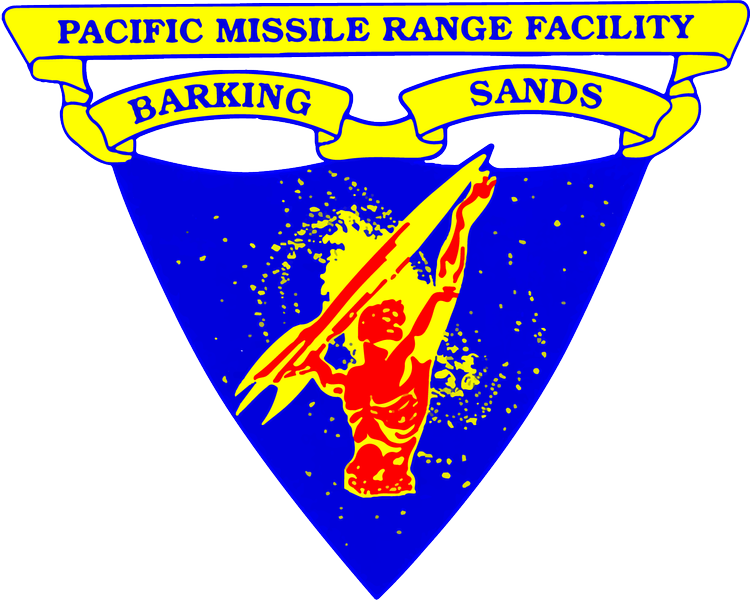 Emblem of the Pacific Missile Range Facility with a silhouette of a muscular man holding a missile, surrounded by yellow and blue colors, with a banner reading "Barking Sands".