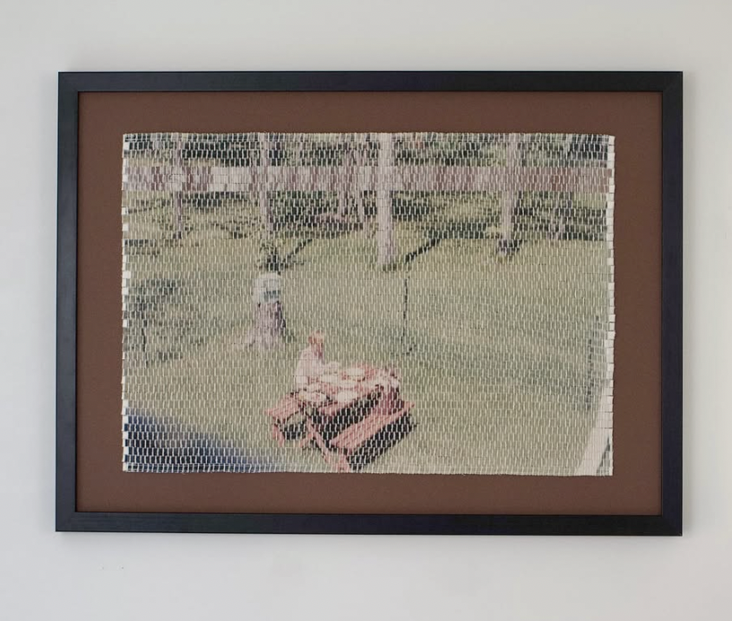 Framed woven artwork depicting a faint, pixelated scene with a red car and architectural background.