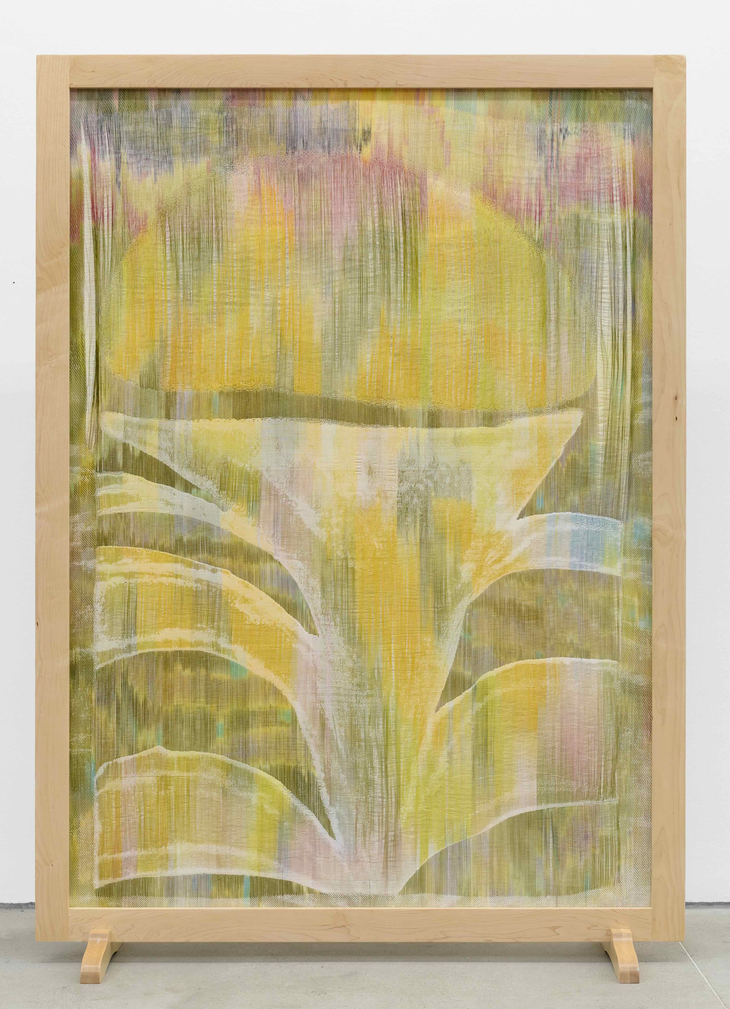 A large wooden frame contains a fiber work featuring watercolor-like washes of yellow, pink, blue, and green. An abstract, plant-like shape makes up the majority of the work.