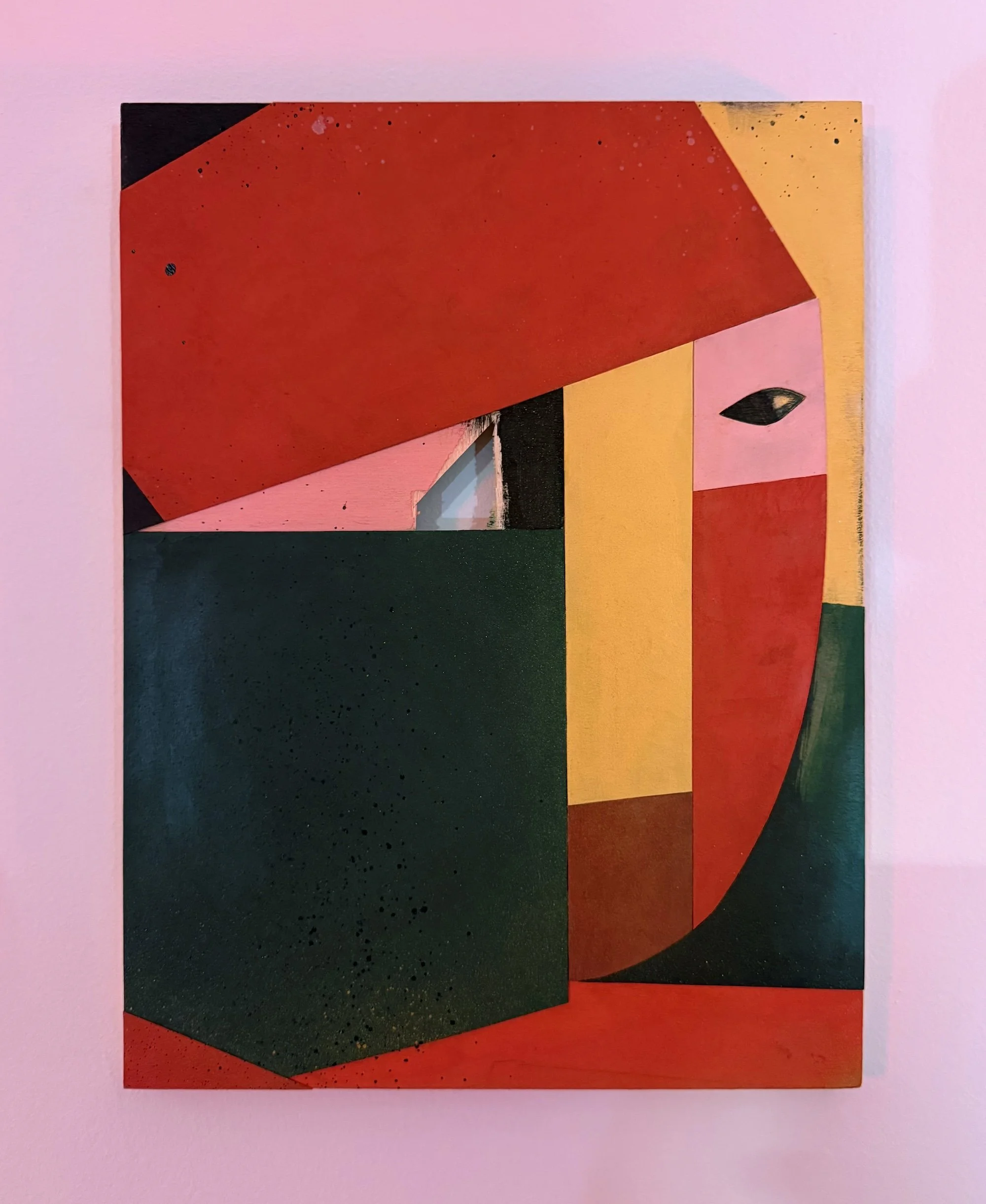 Abstract geometric painting composed of red, green, yellow, and black planes, featuring a small eye-like form embedded in the composition.