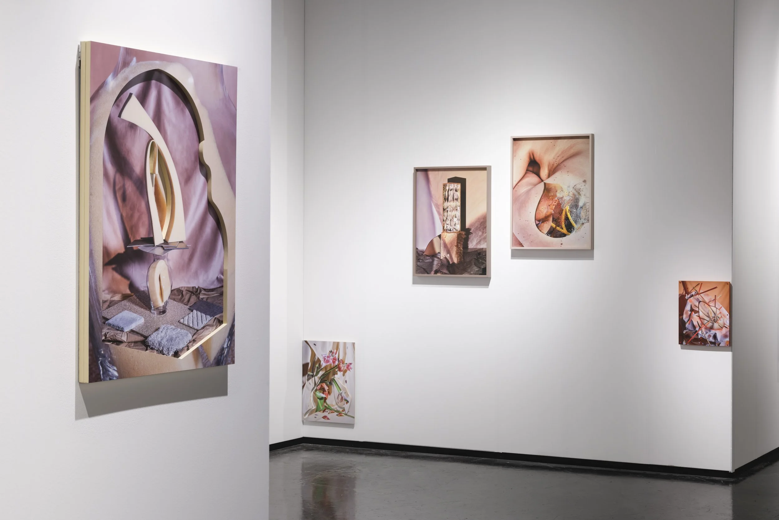 Gallery wall with one large abstract print on the left and three smaller framed works arranged on the right.