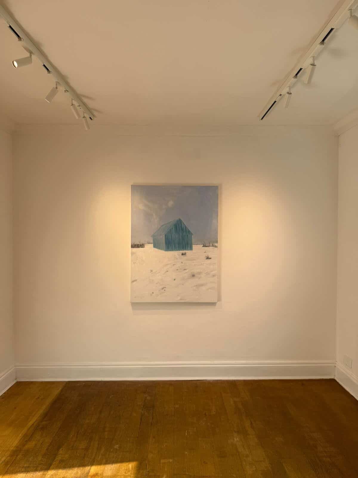 Painting of a turquoise shed standing alone in a snowy field beneath a pale blue sky.