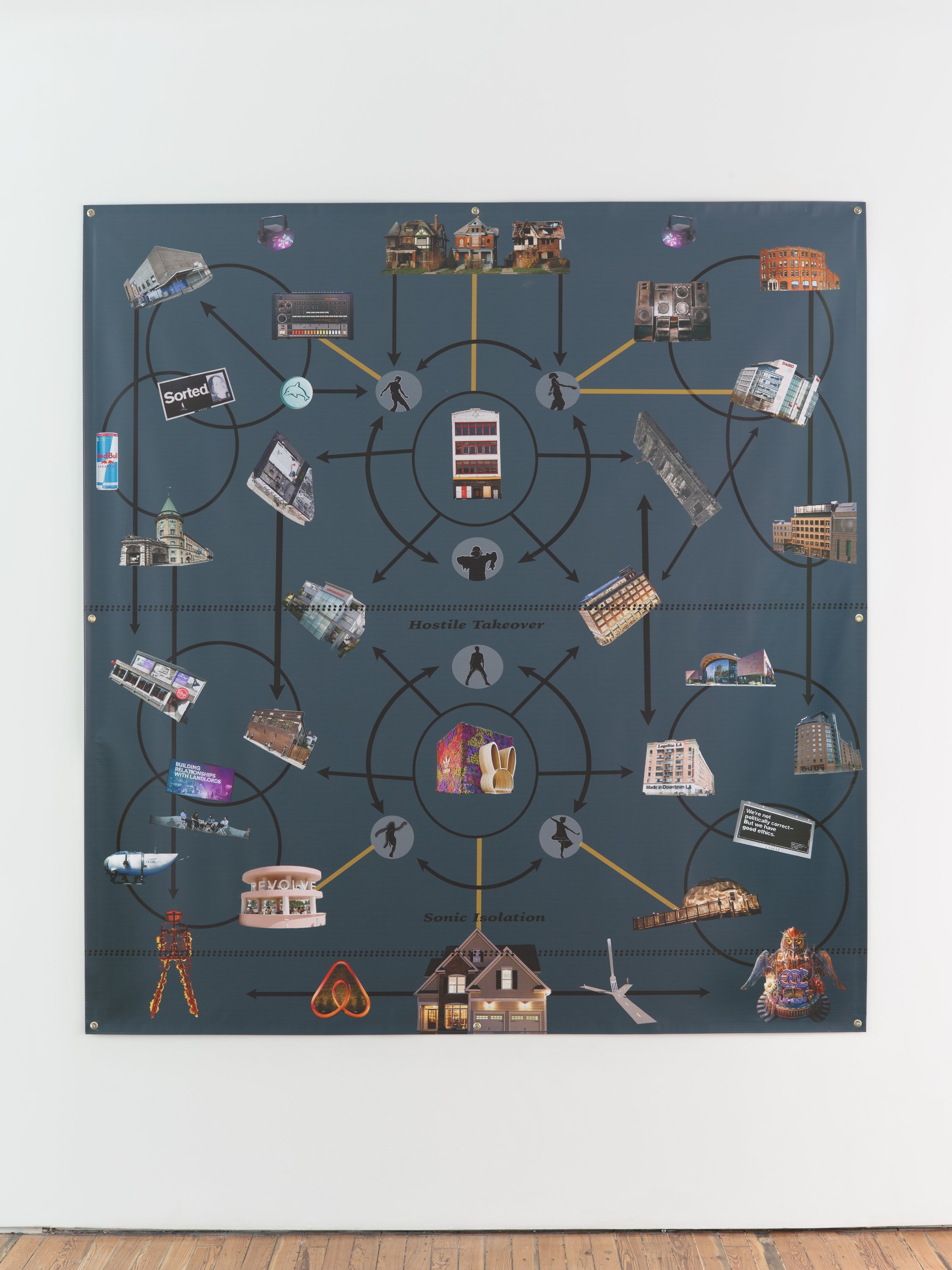 A 2D work mounted to a white wall is comprised of A grey background with cutout images of various buildings, signs, and objects connected by lines and black arrows, creating a diagrammatic composition.
