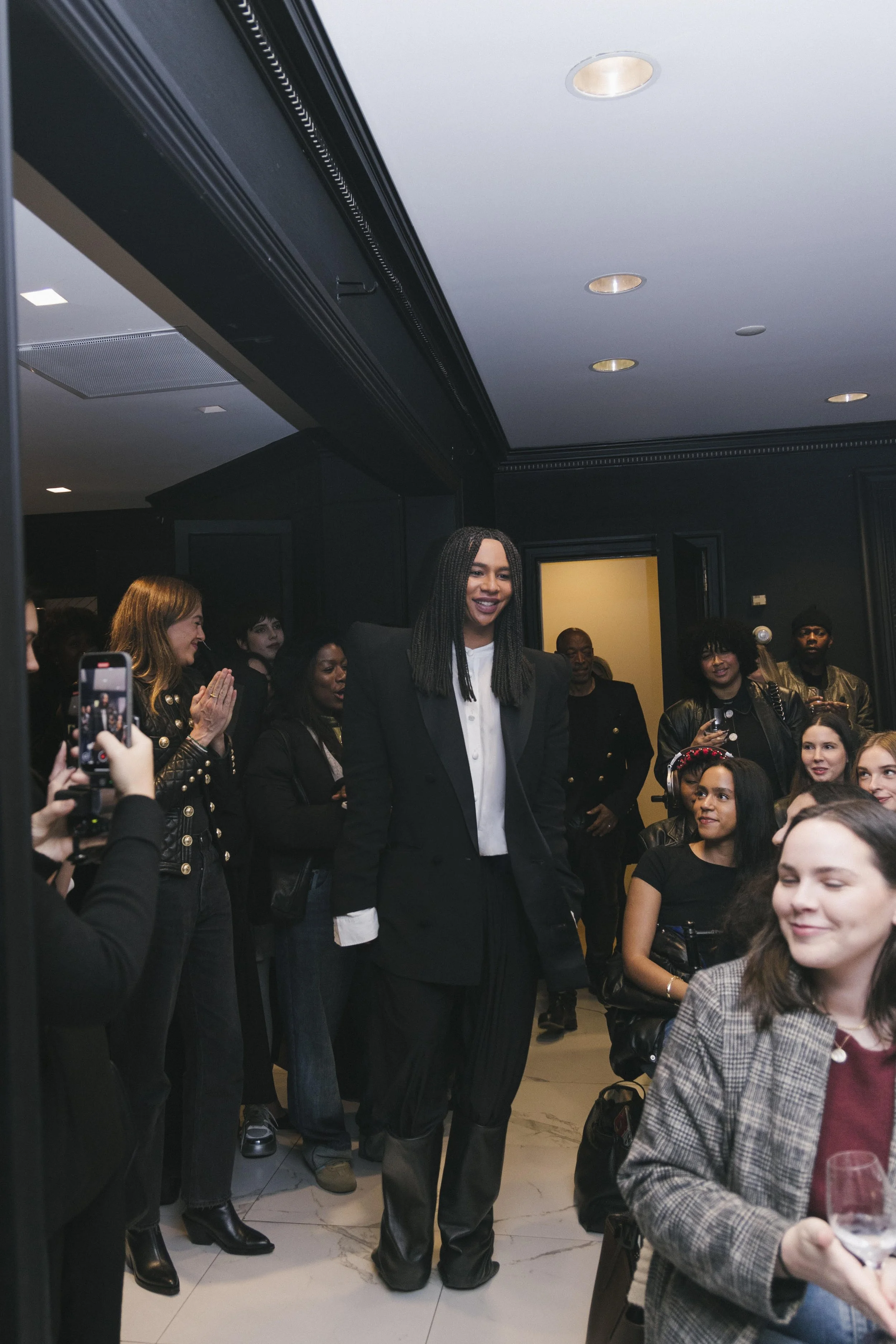 Olivier Rousteing in Bergdorf Goodman, smiling as we walks past students.