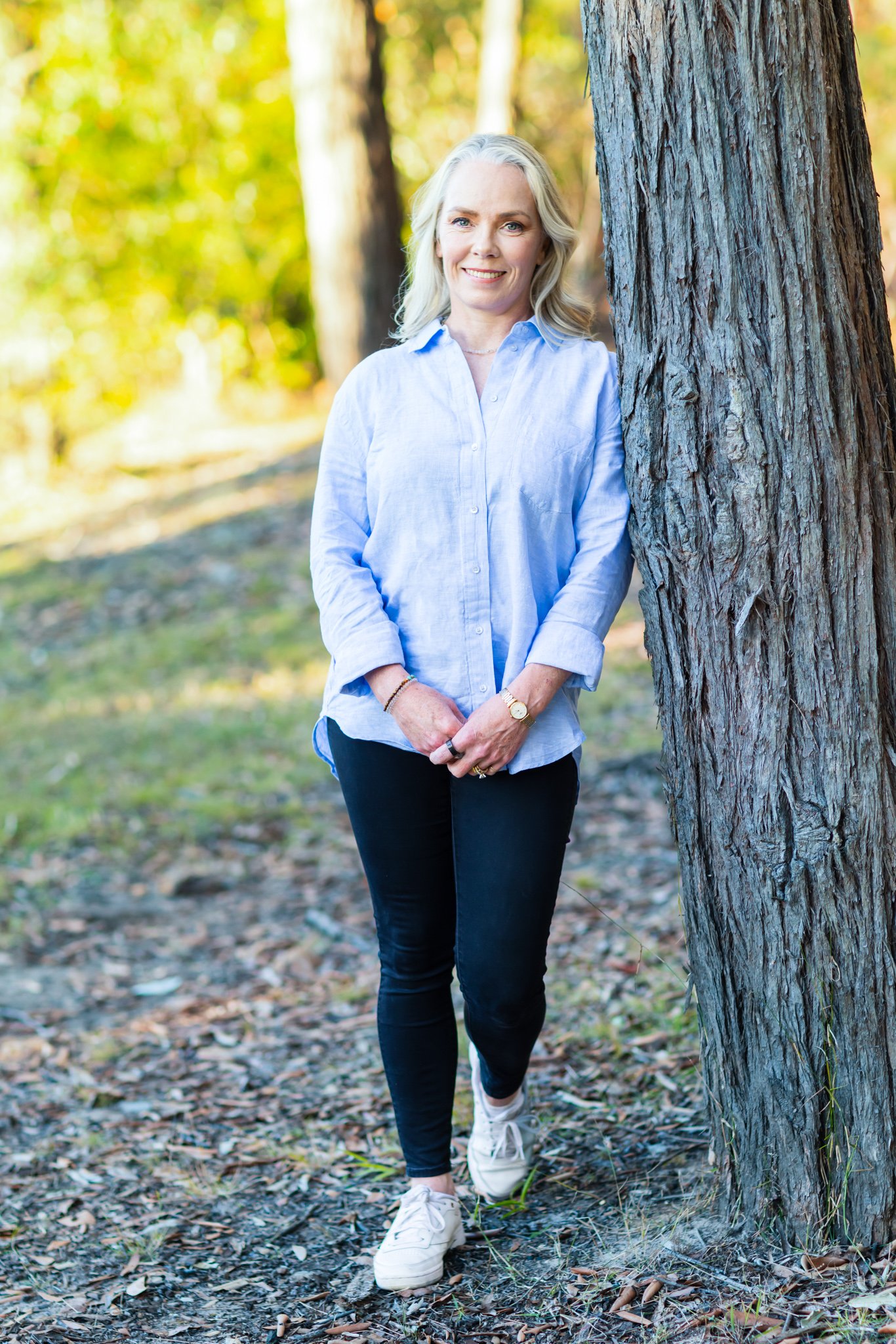 Woman leaning on tree