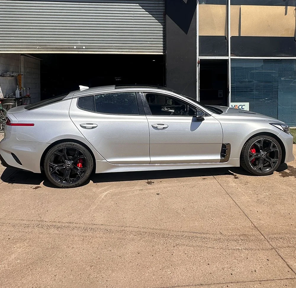 Car accident damage repairs along the side of a silver sedan by Phantom Autobody