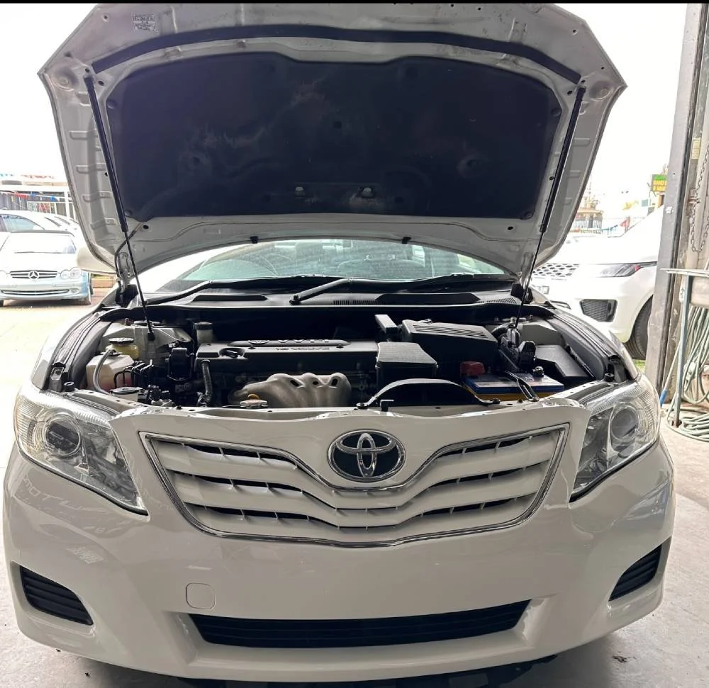 Front of white car with hood open