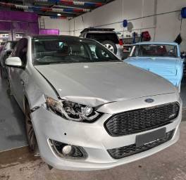 Car accident damage to silver car front bumper, body and headlights
