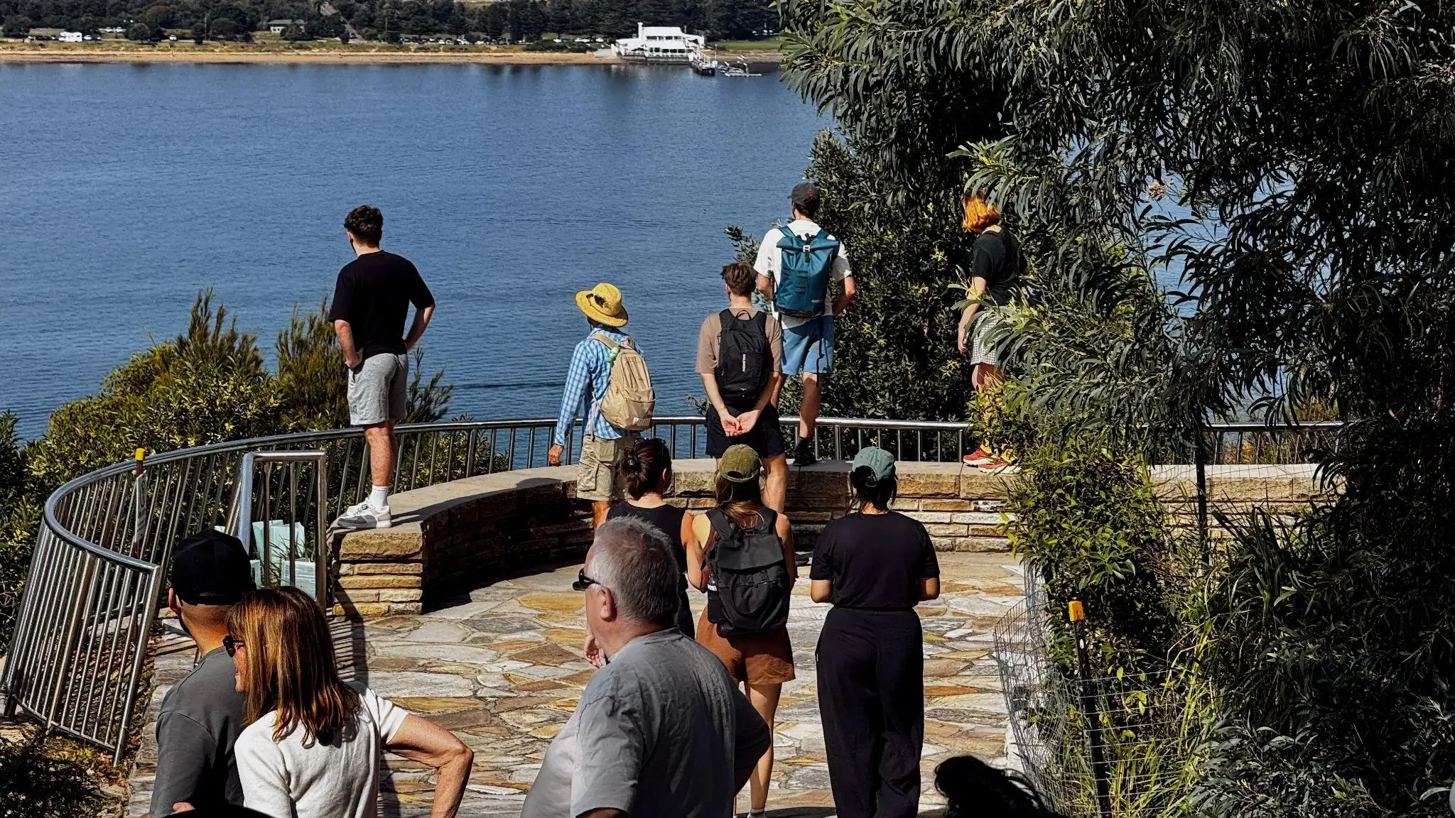 Visitors viewing an Aboriginal engraving site from a boardwalk in a NSW national park