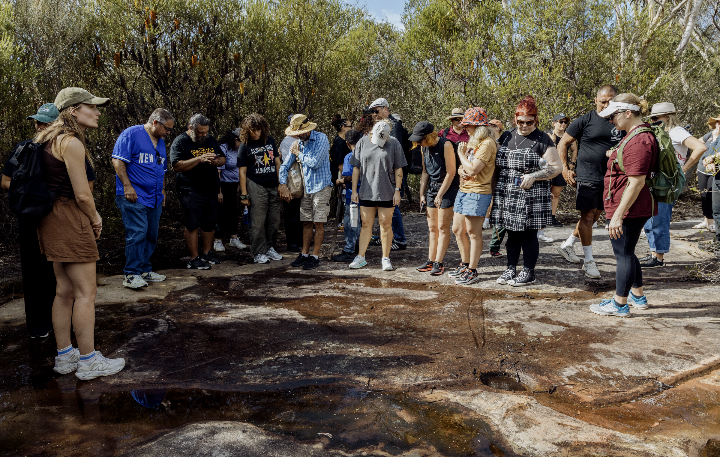 A group of people listening to Eric Brown lead sharing stories in a New South Wales national park.