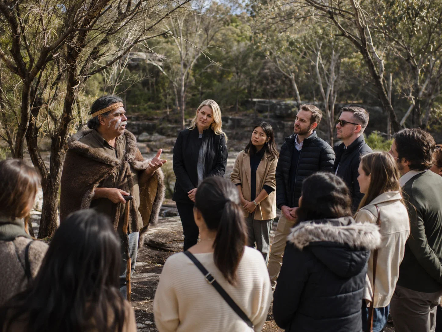 Guests listening respectfully during an Aboriginal cultural welcome.