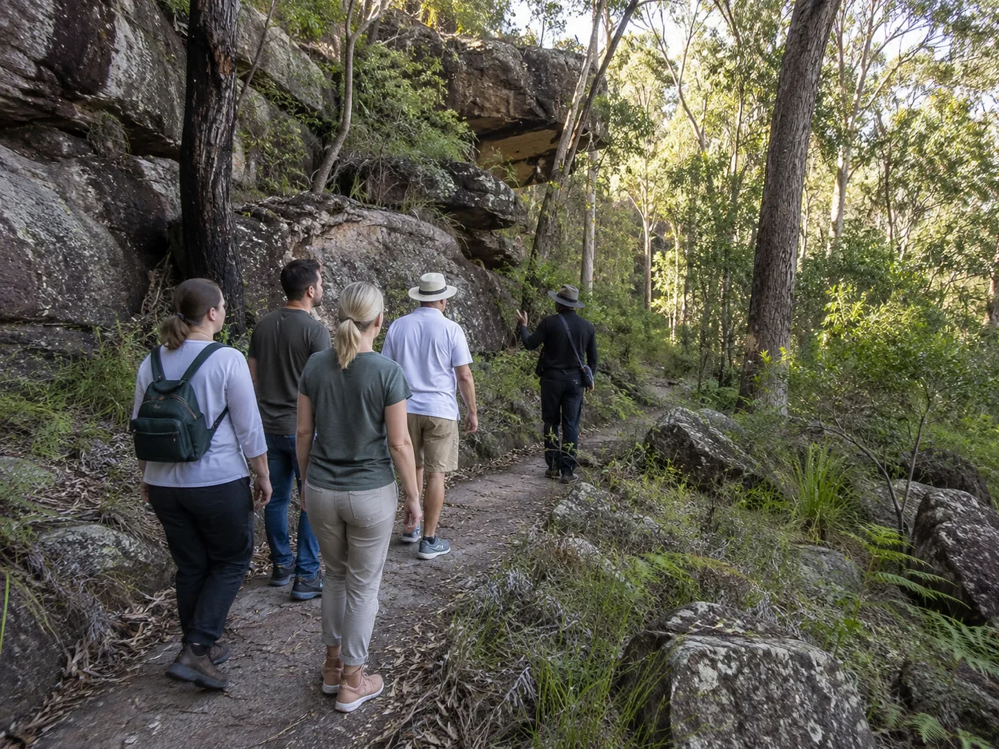 Visitors walking respectfully on Country with an Aboriginal guide