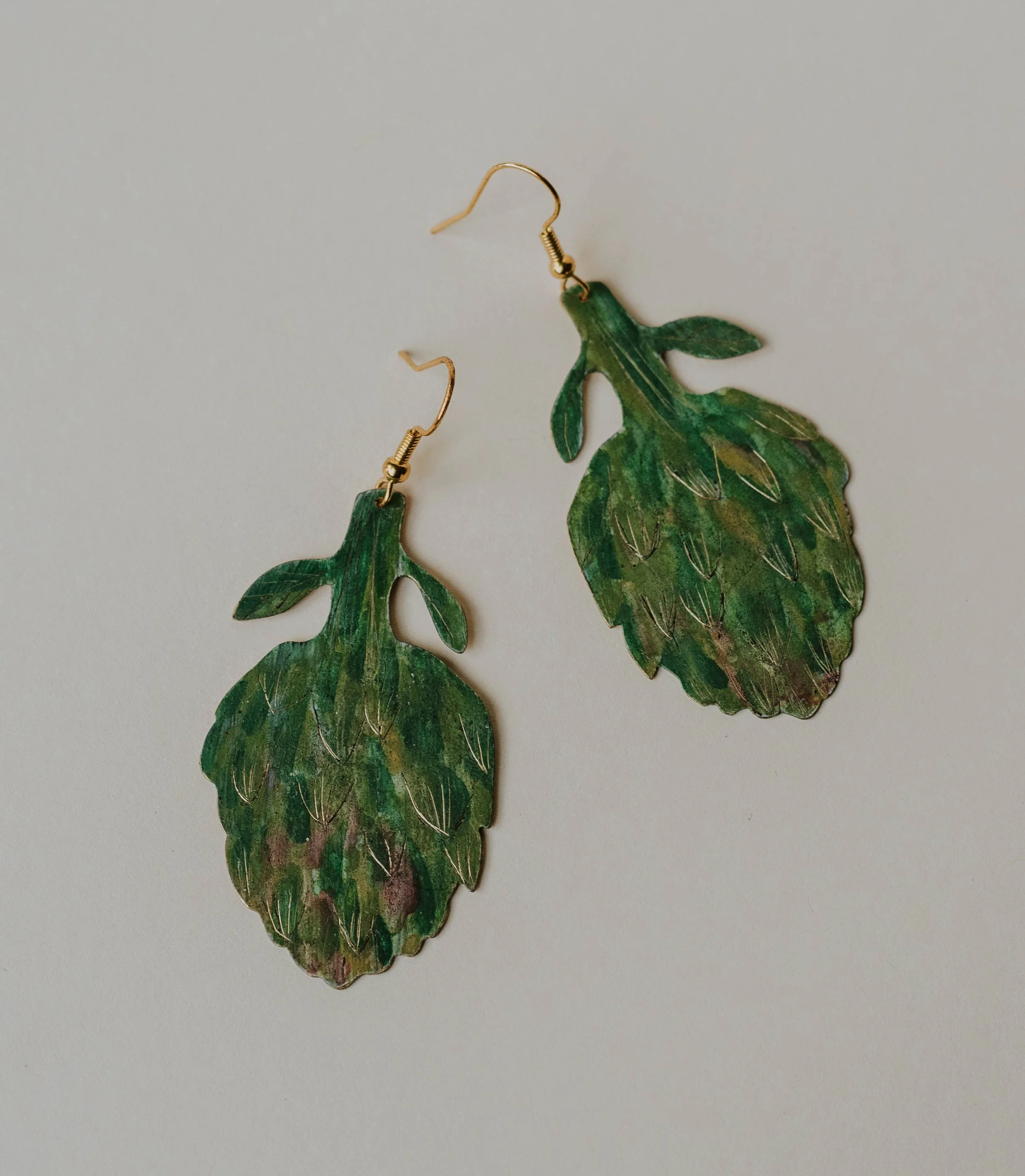 Large painted brass artichoke earrings measuring 6 x 3 cm.