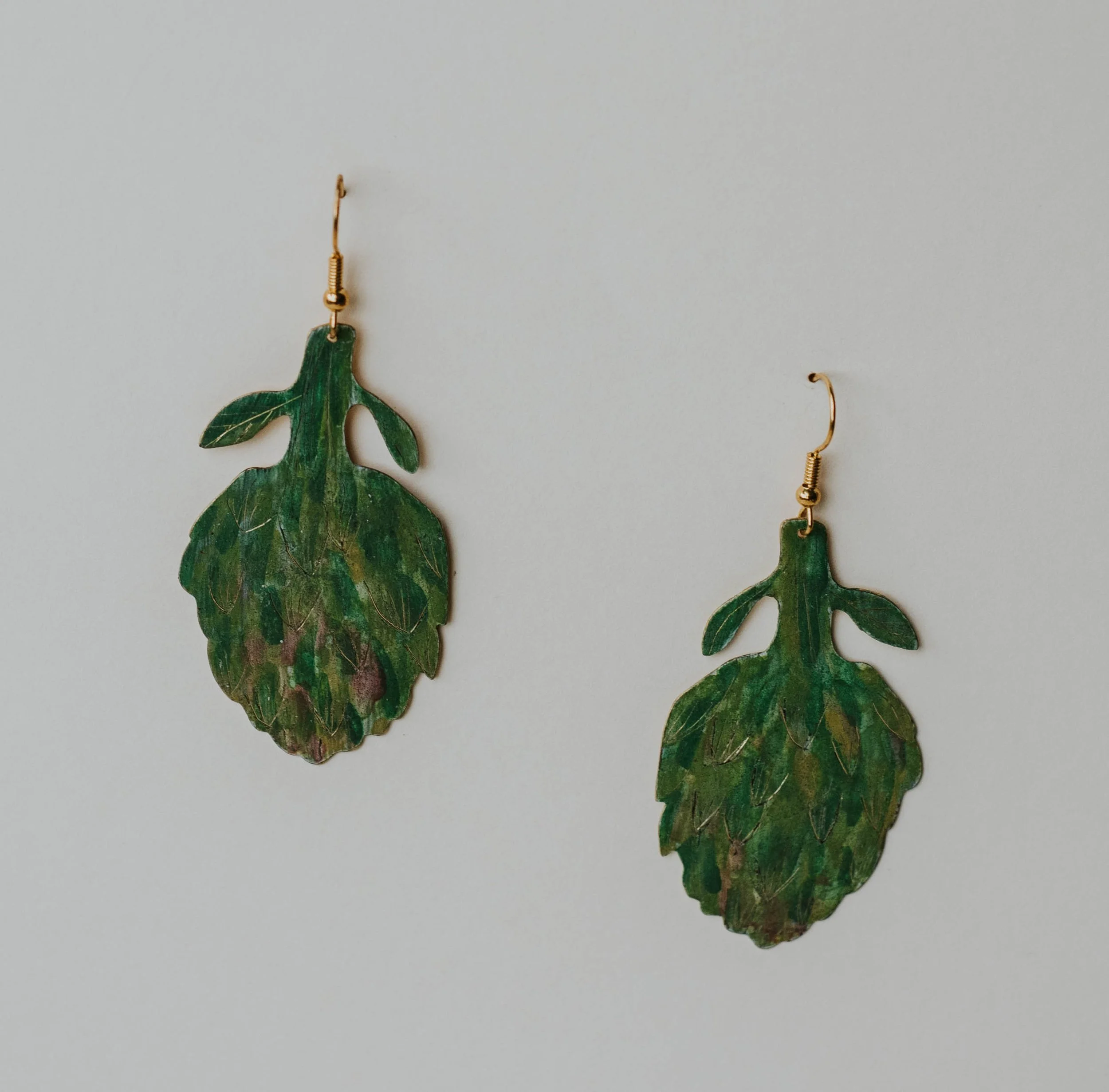 Large painted brass artichoke earrings measuring 6 x 3 cm.