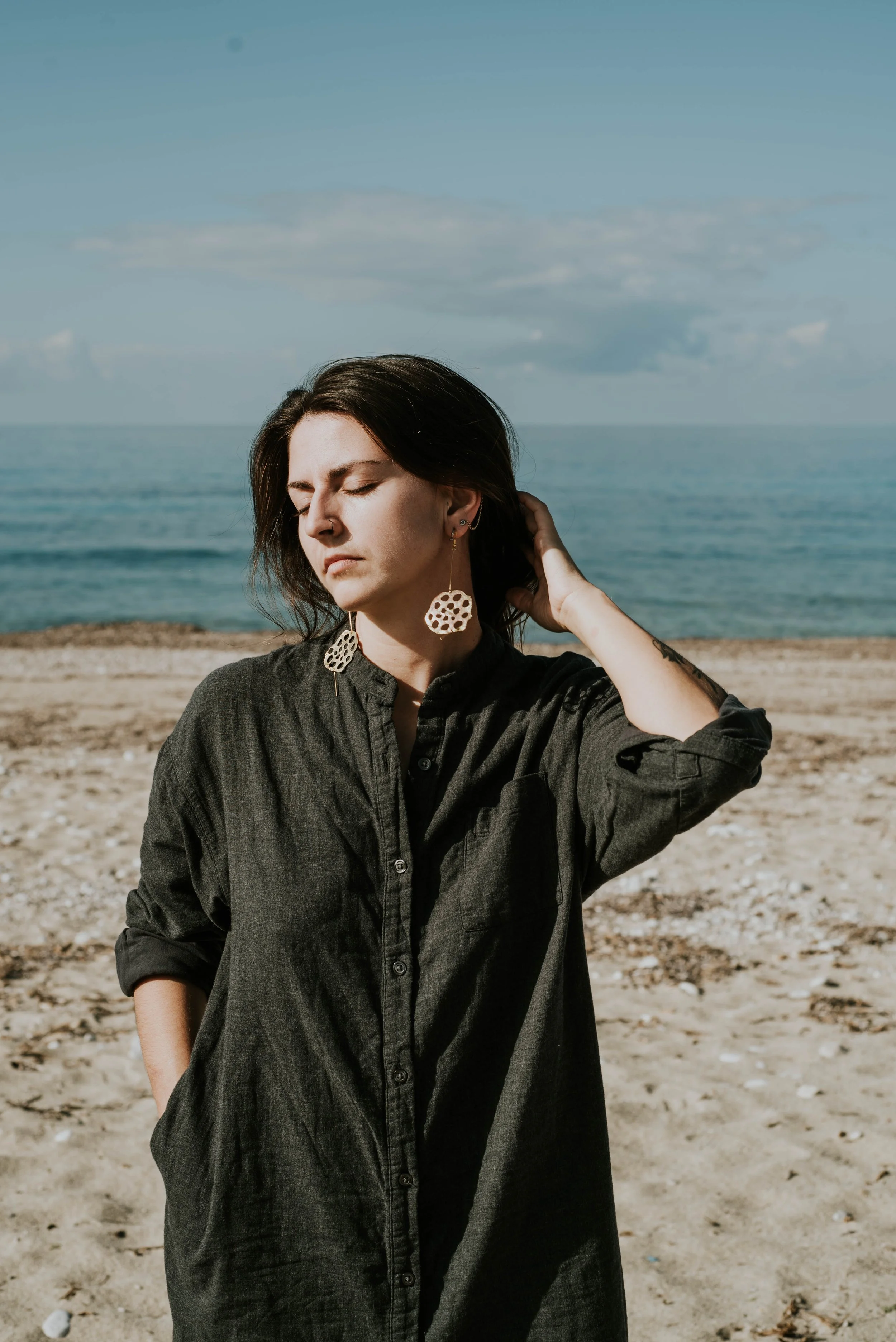 Bold brass statement earrings inspired by lotus seedpods. Elegant, sculptural handmade jewelry with an organic form and strong presence.