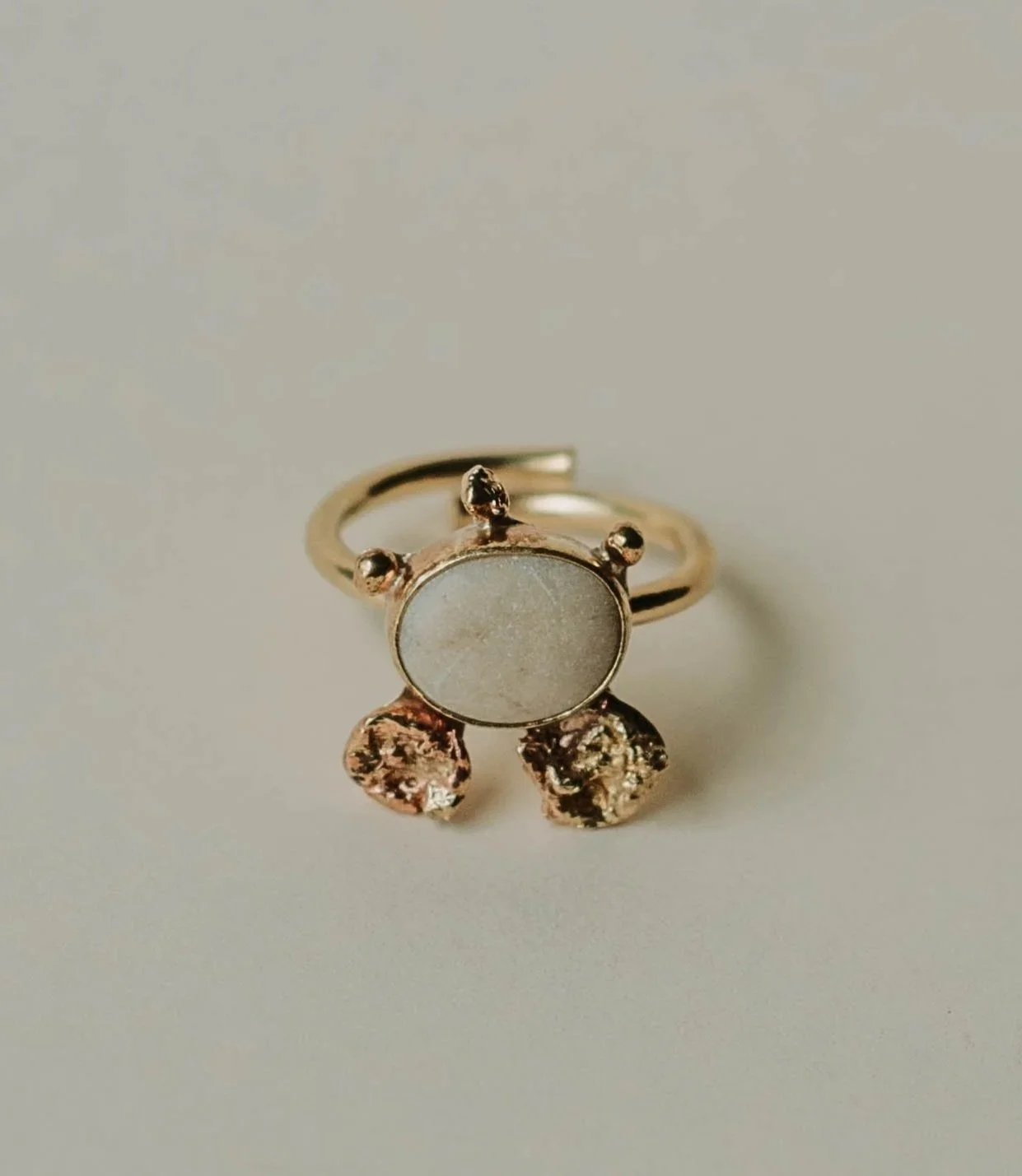 One-of-a-kind adjustable brass ring with a naturally worn white pebble from the Lefkada coast and molten brass accents.