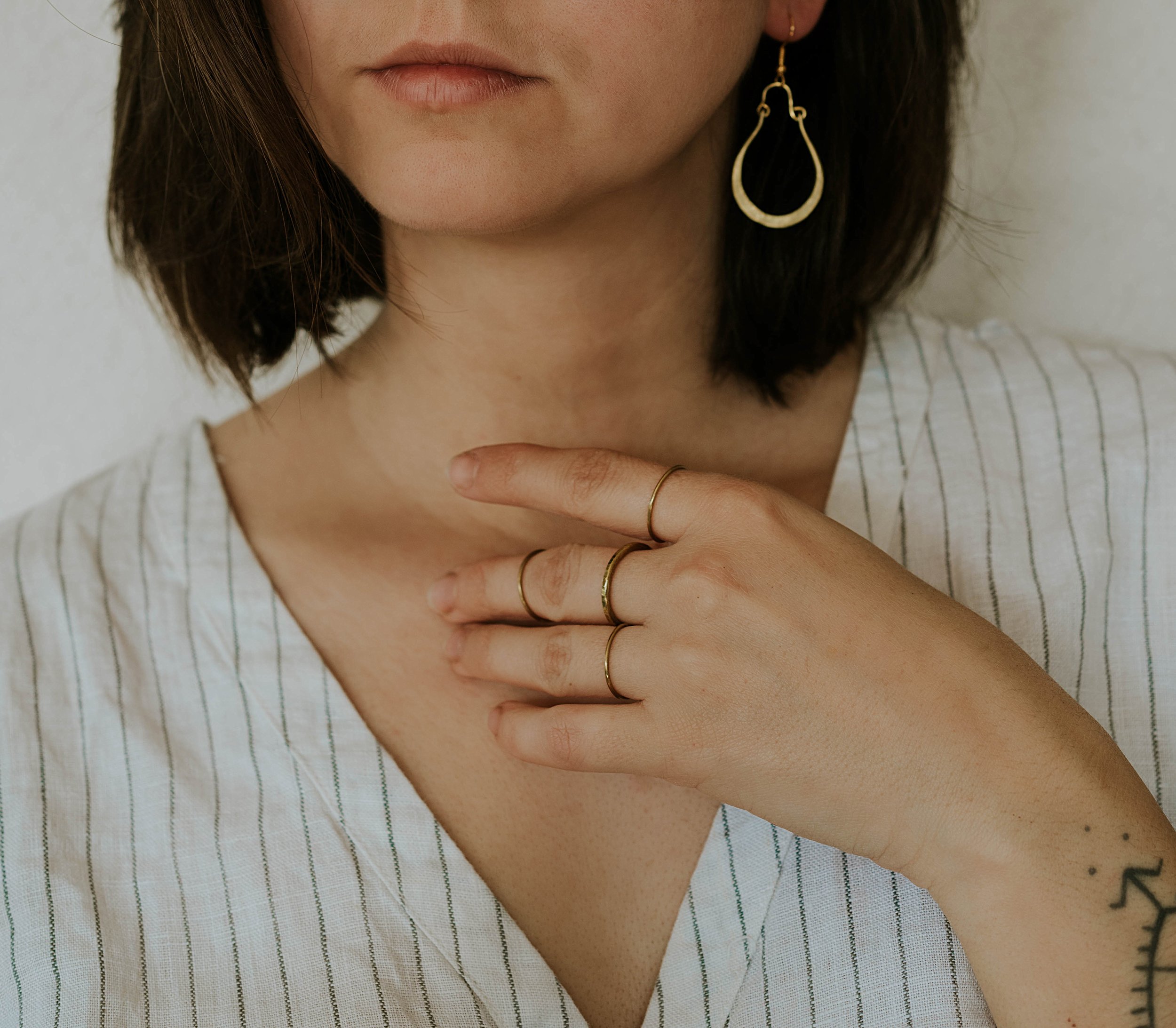 Hammered brass hoops inspired by ancient jewelry and simple lines.