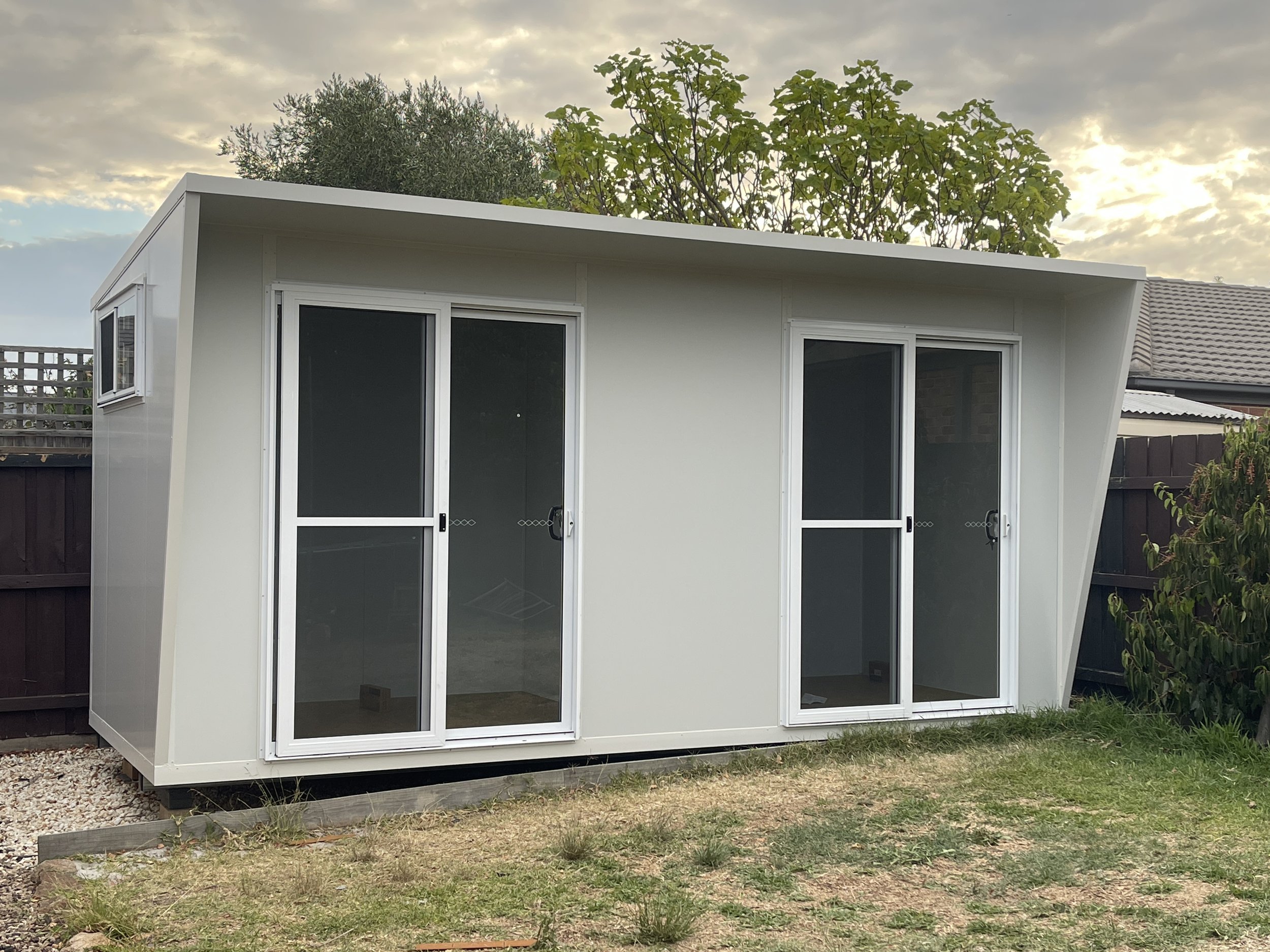 Two-in-one backyard office pod in Melbourne with cantilever roof design and dual sliding doors