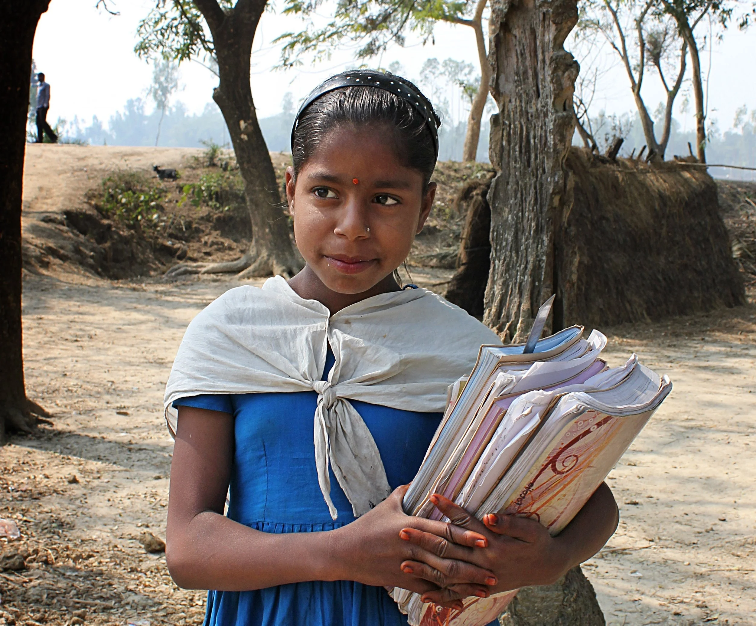 A girl holding school books