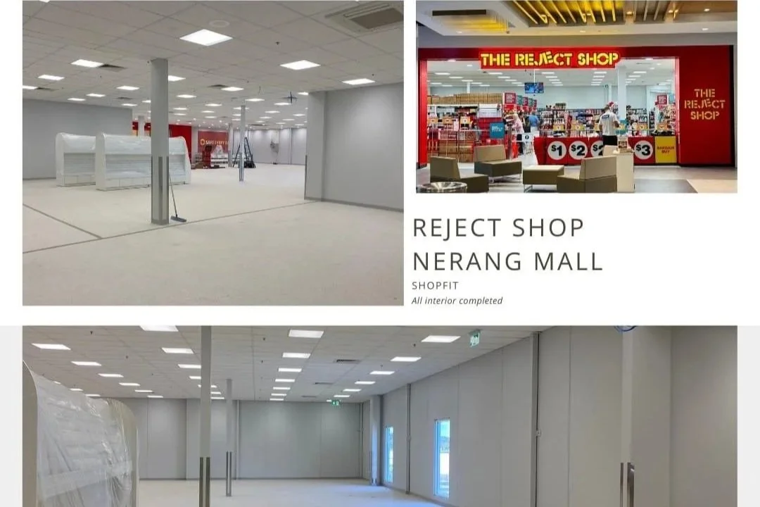 Exterior of Little Kiwi Bakehouse with black building, large white sign, steps leading up to entrance, sidewalk with plants, and a large tree on the right.