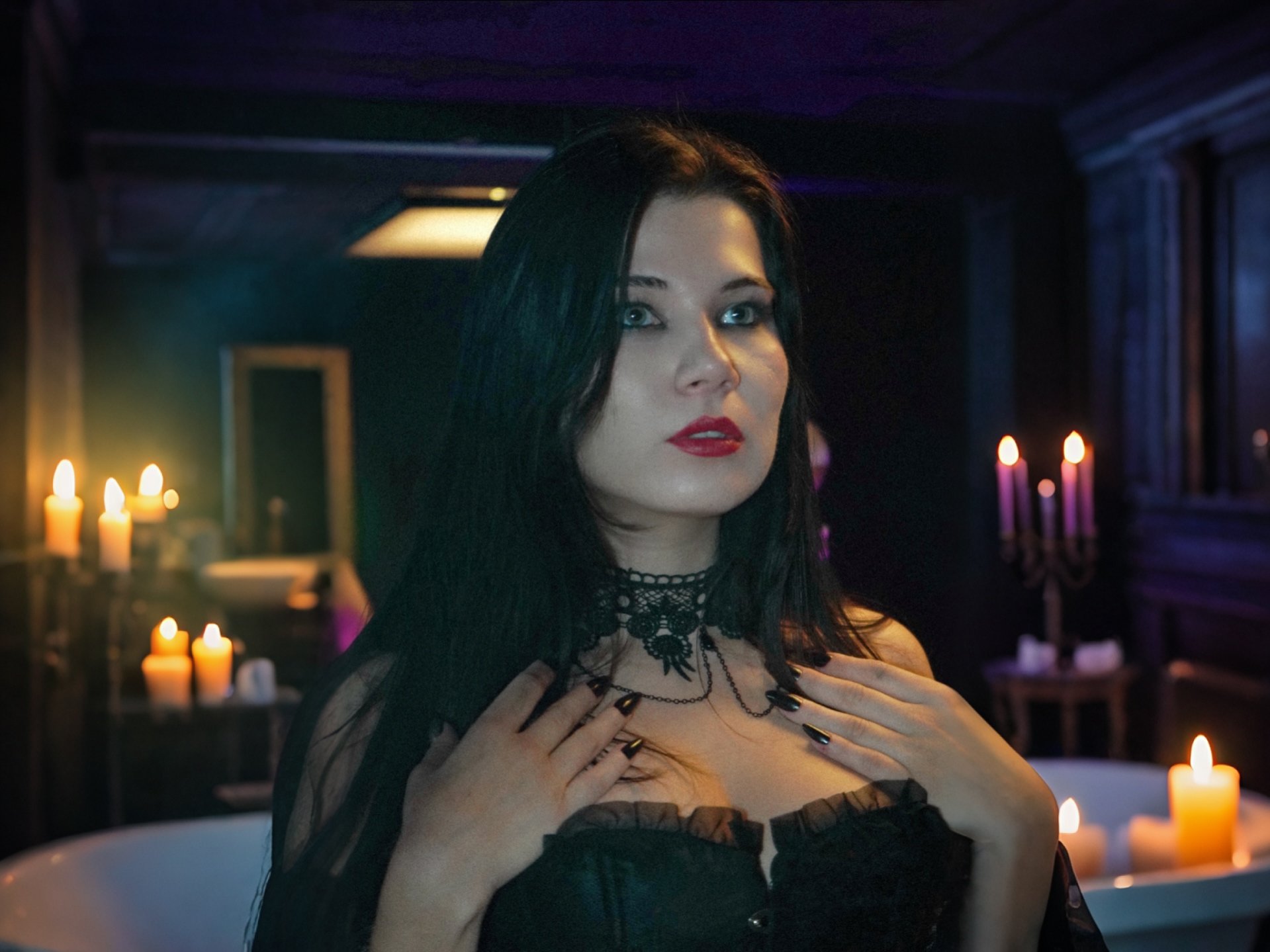 Gothic dark pop artist LAVANDER BLACK in a room with candles lavender black