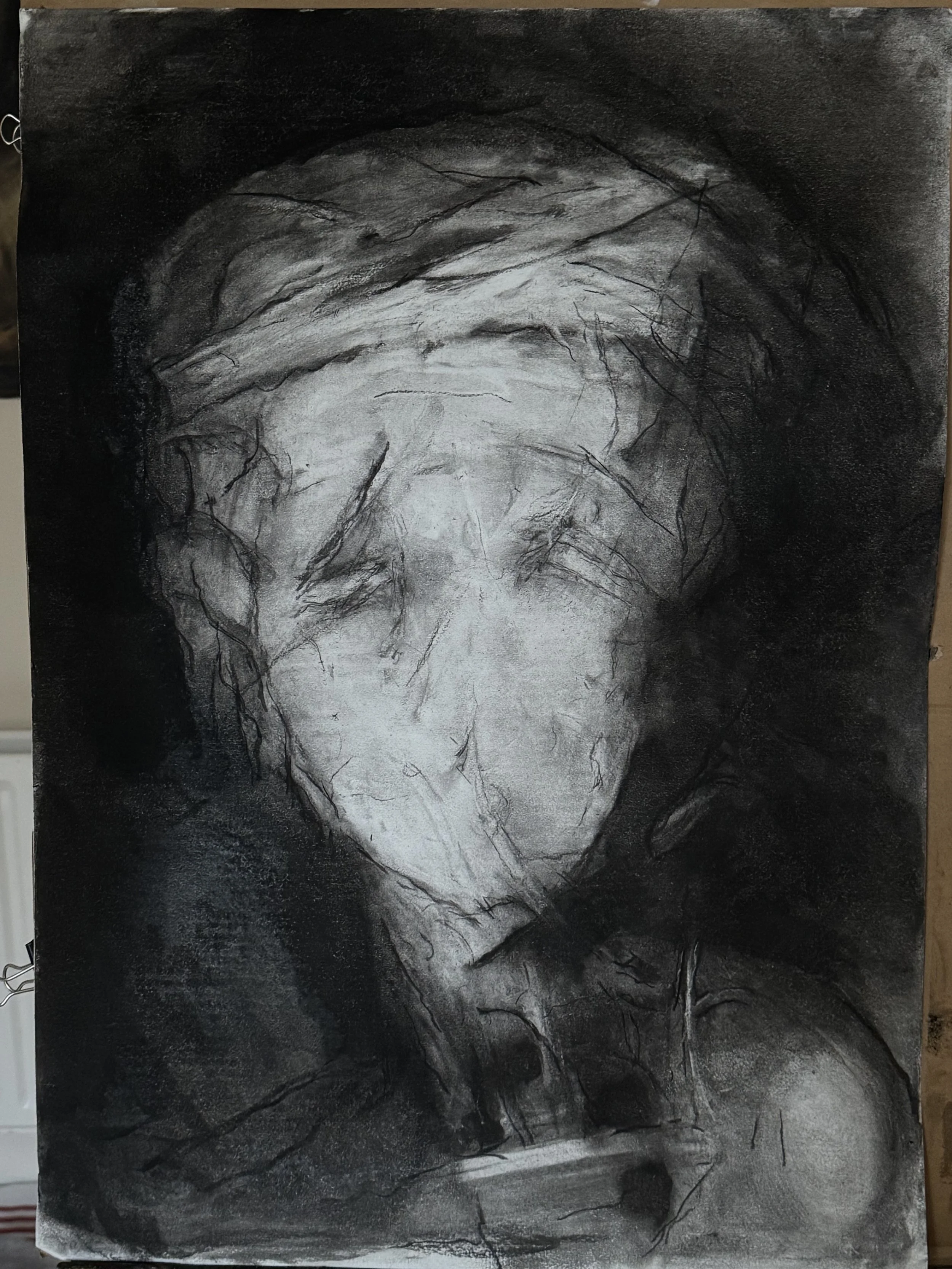 A monochrome abstract portrait of a person's face with closed eyes, depicted with sketchy, expressive lines and shading, creating a somber and introspective mood.