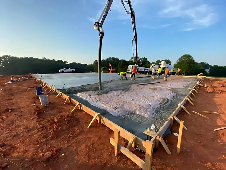 Crew finishing a concrete building slab
