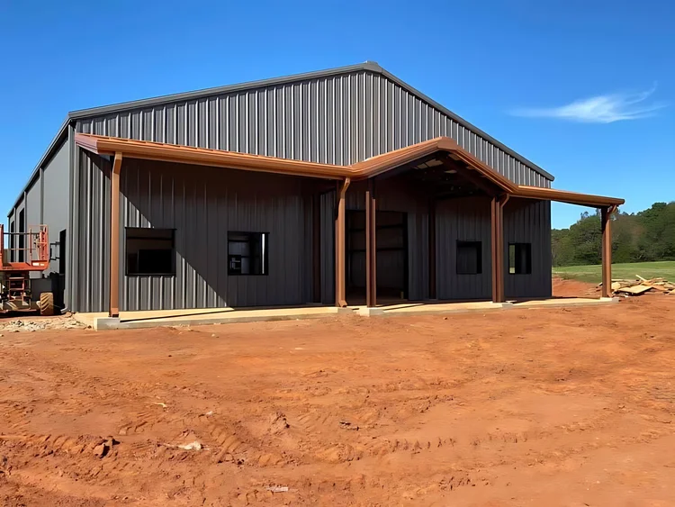 Dark gray barndominium with a wood-post front porch