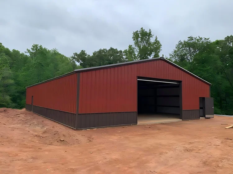 Red steel barn with an open equipment bay