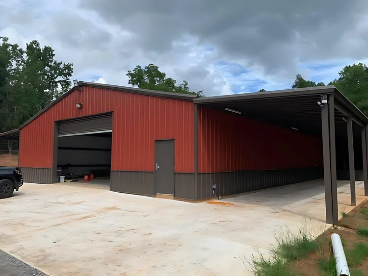 Red steel barn with a lean-to