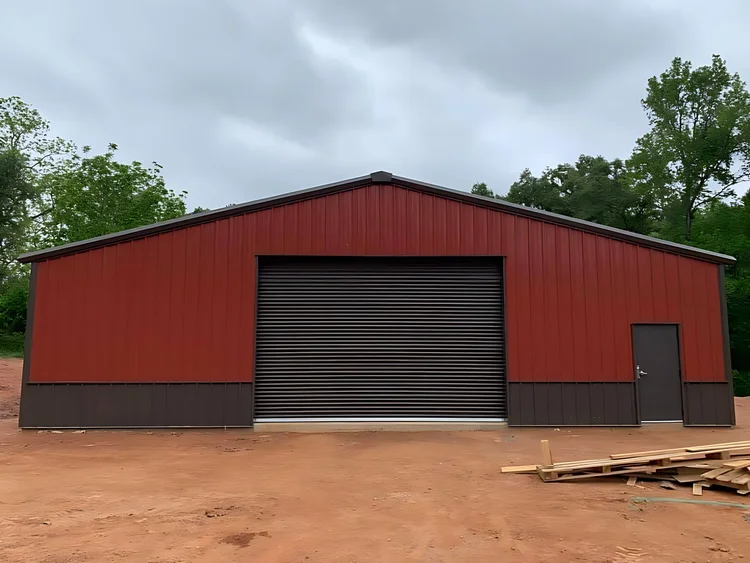 Red steel barn with roll-up door