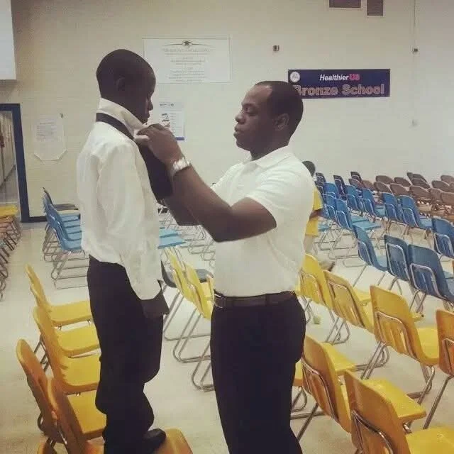 Helping a young man with his tie