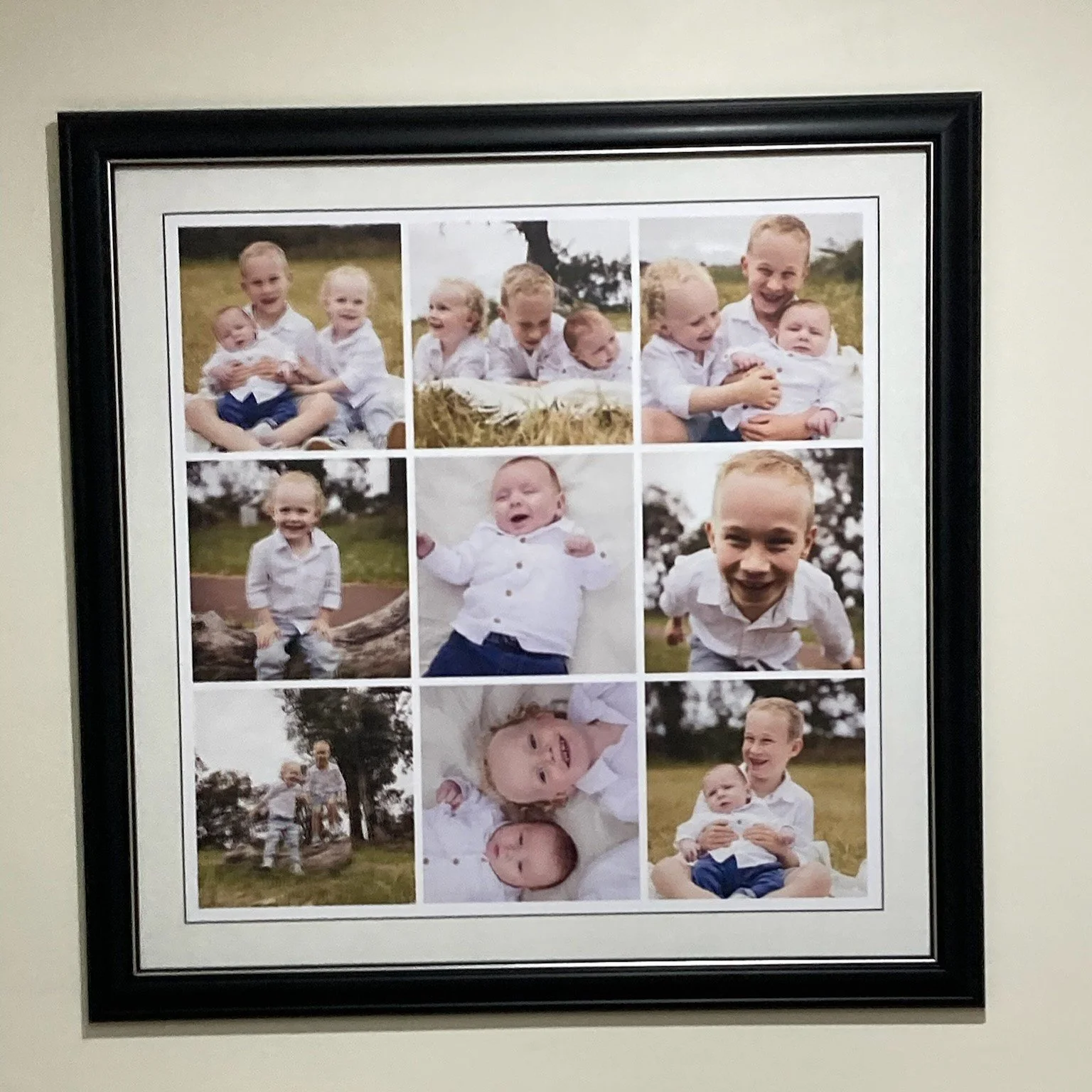 A framed collage of nine photos of young children, mostly boys, playing and smiling outdoors, dressed in casual white shirts and shorts, in a park or open field.