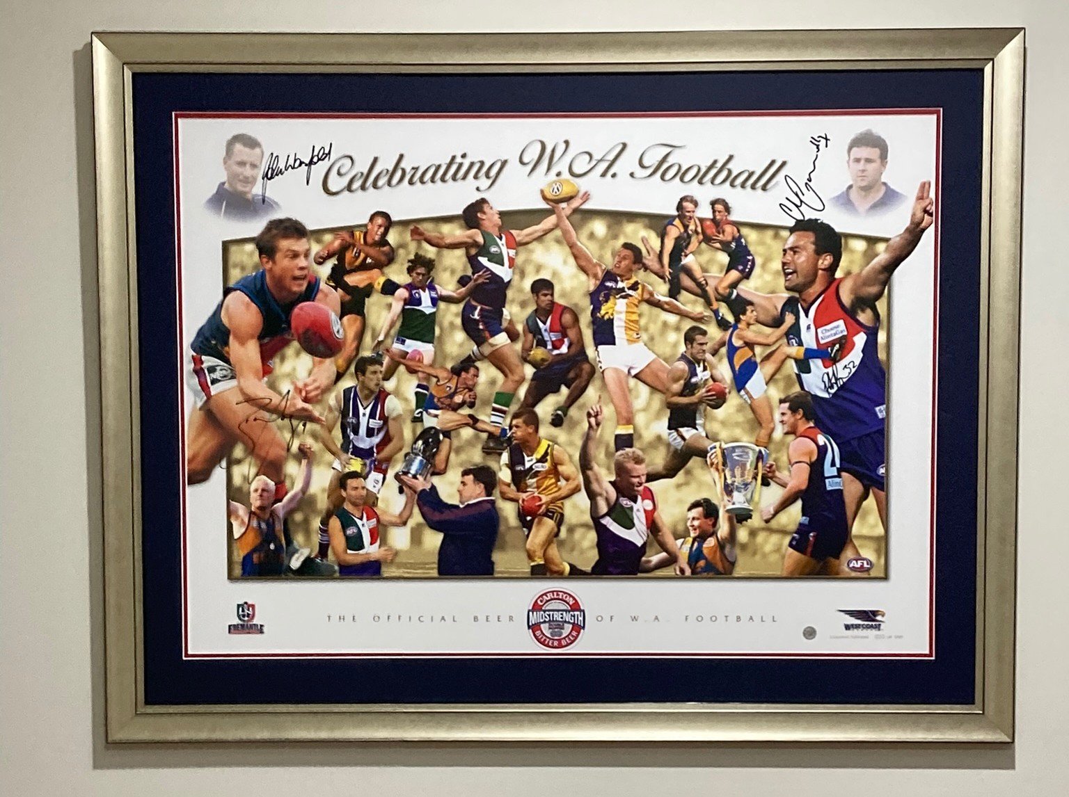 Framed collage celebrating WA football with players, coaches, and autographs.