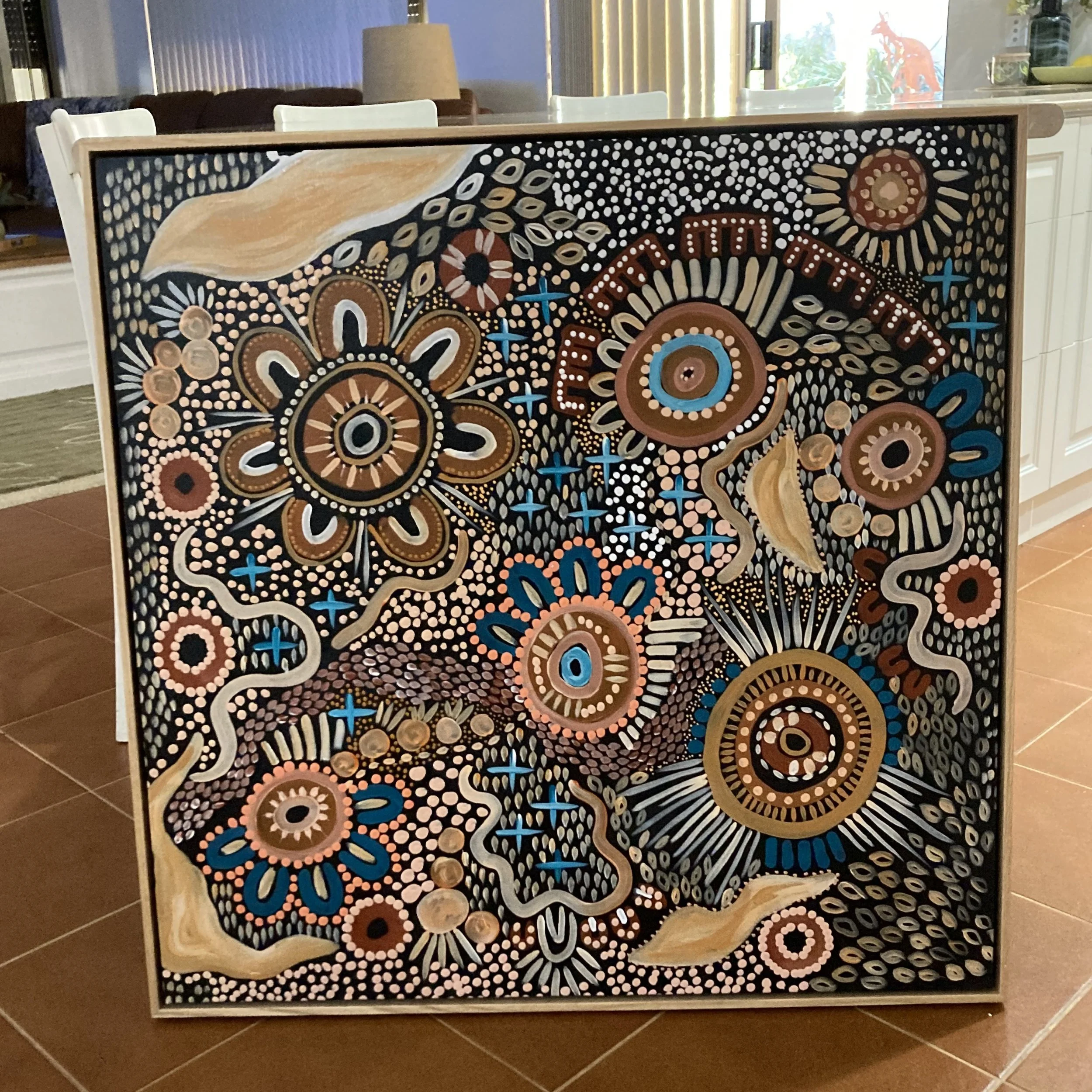 Abstract painting with intricate circular patterns in beige, brown, white, black, pink, and blue, resembling stylized flowers and spiral motifs.