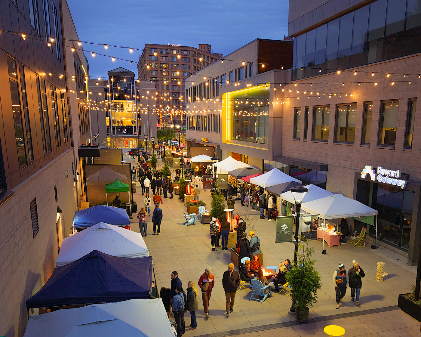 Drone photo of Moonlight Market at The Grove in downtown Rochester, NY with vendors, tents, and shoppers walking through The Grove