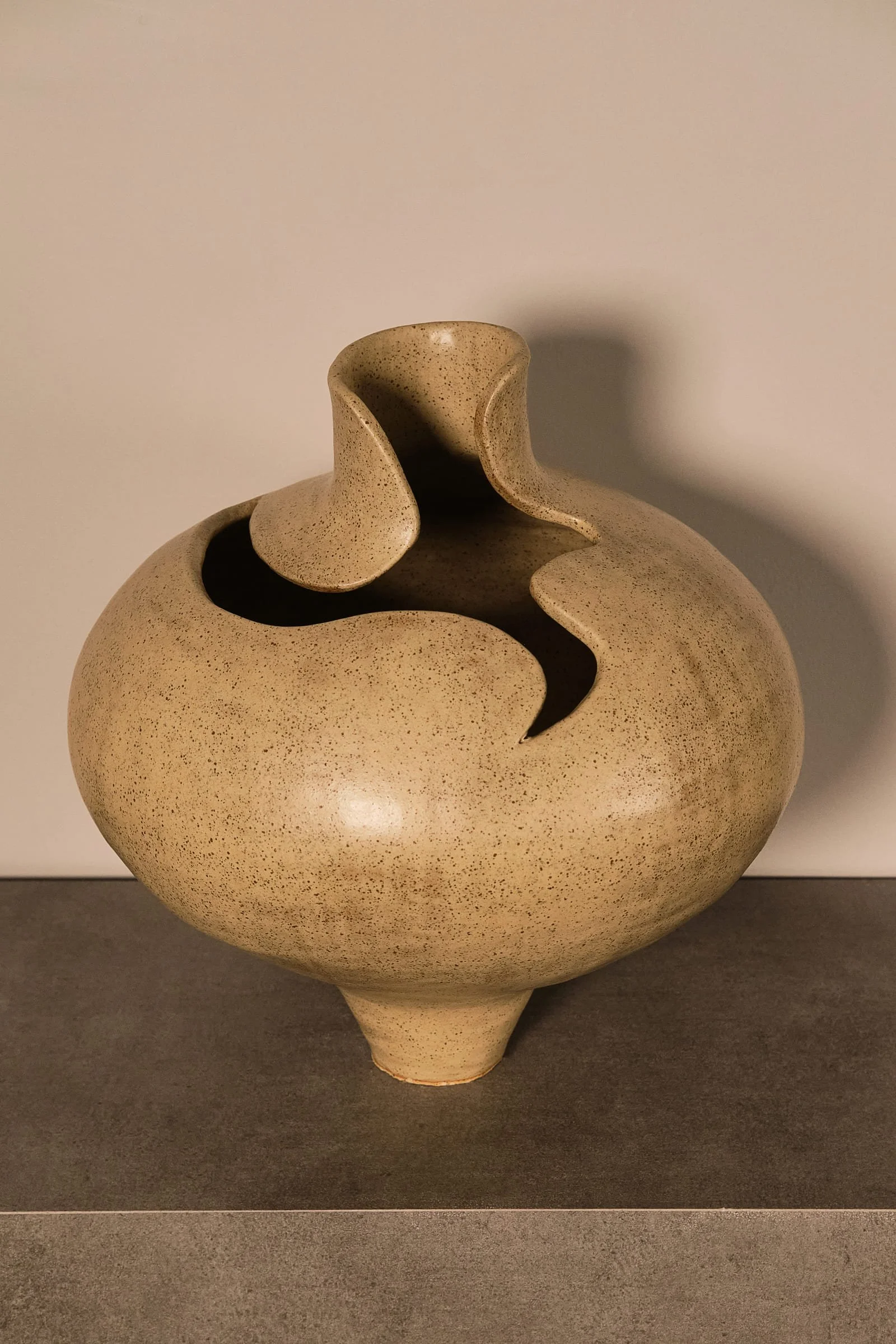 Sculptural ceramic object displayed in a contemporary interior.