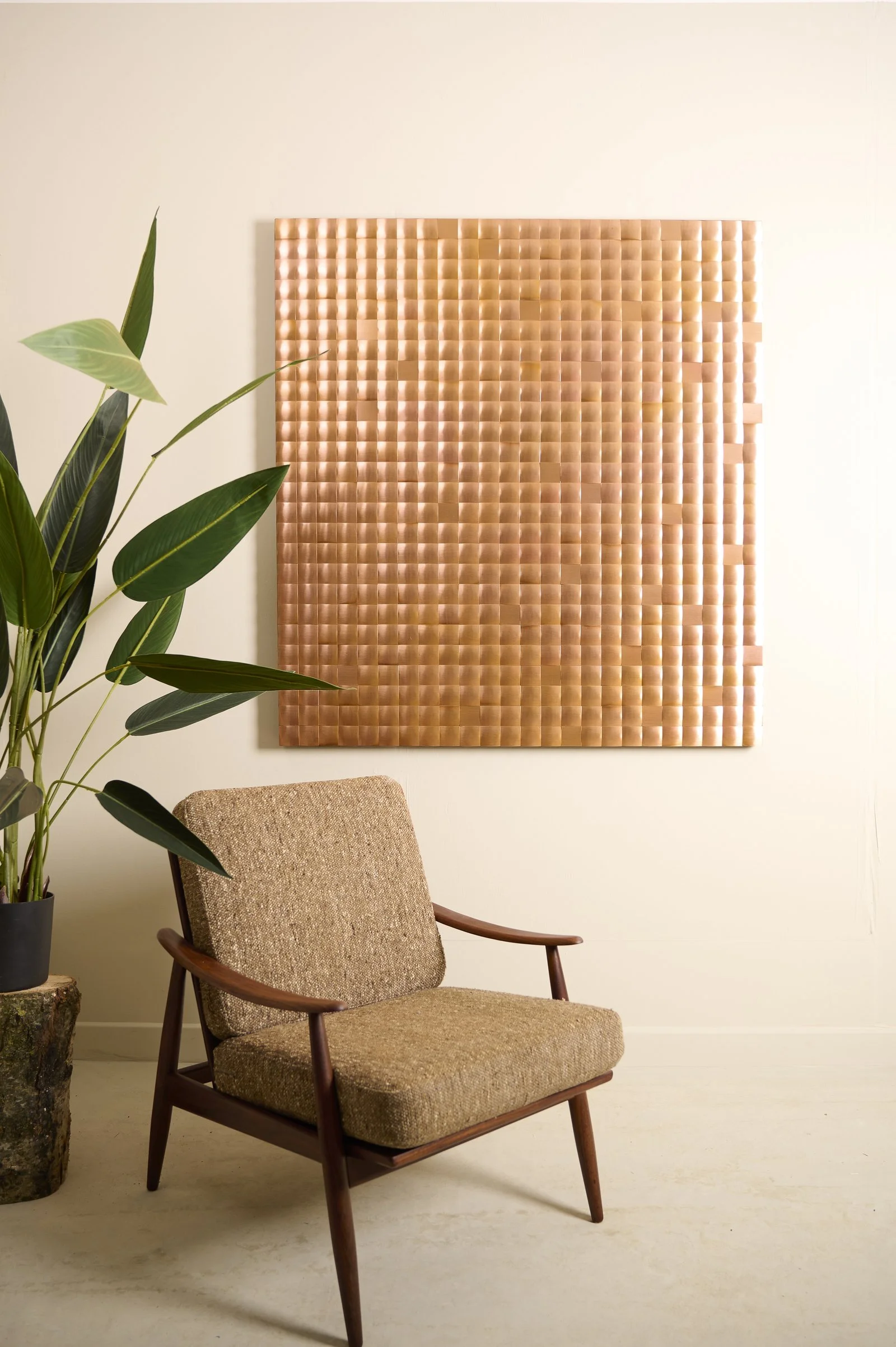 Reflective copper wall sculpture in interior