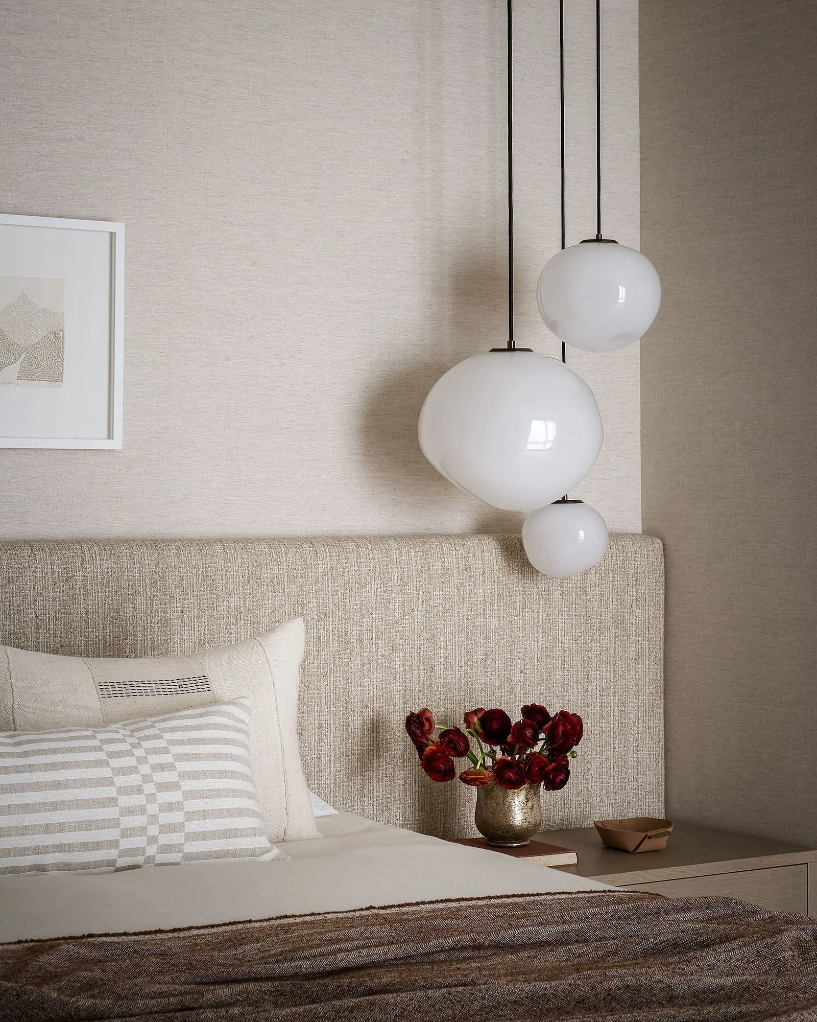 Warm neutral bedroom with tactile textures and soft lighting