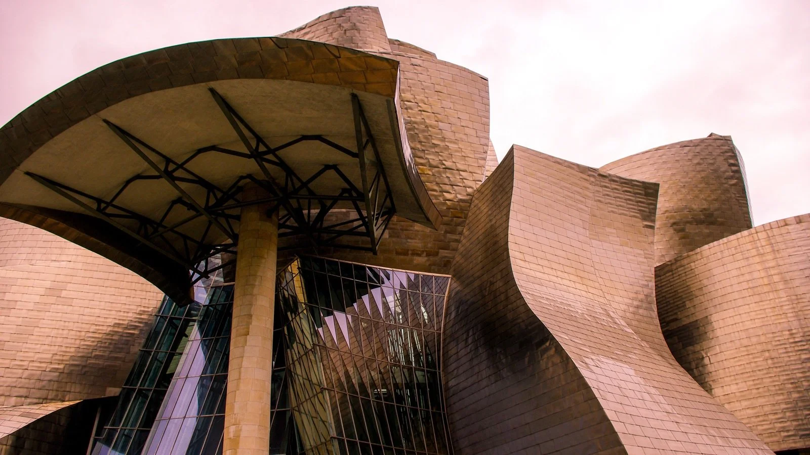 Frank Gehry's titanium curves catching the light along the Nervión River at the Guggenheim Museum Bilbao