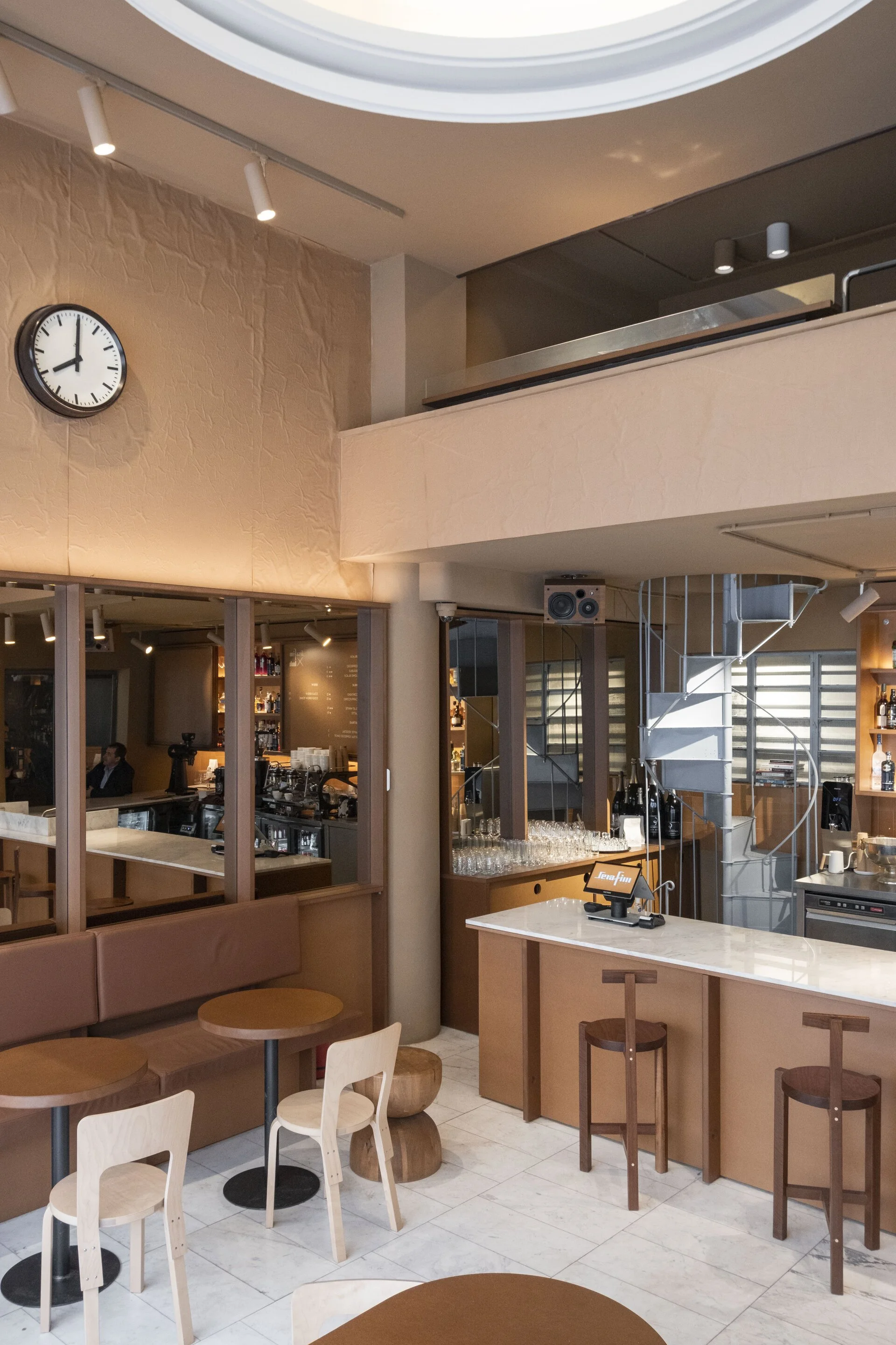 Serafim coffee bar interior with minimal furniture and soft natural light in Bucharest