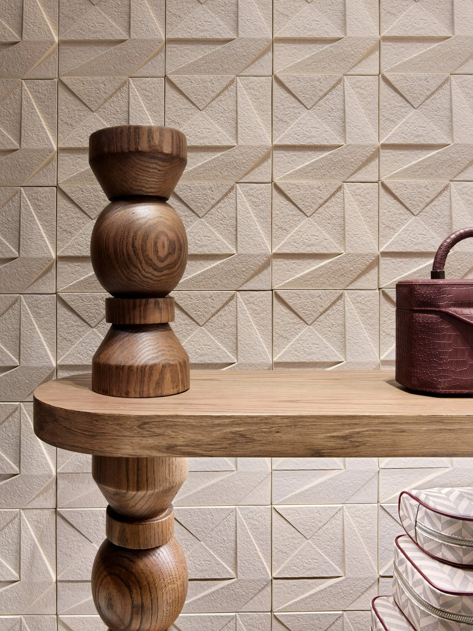 Detail of textured wall and natural materials in 21A Interiors space