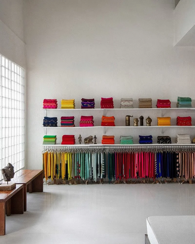 Interior of Raw Mango's Mumbai store, showcasing contemporary Indian textiles and material-led retail design.