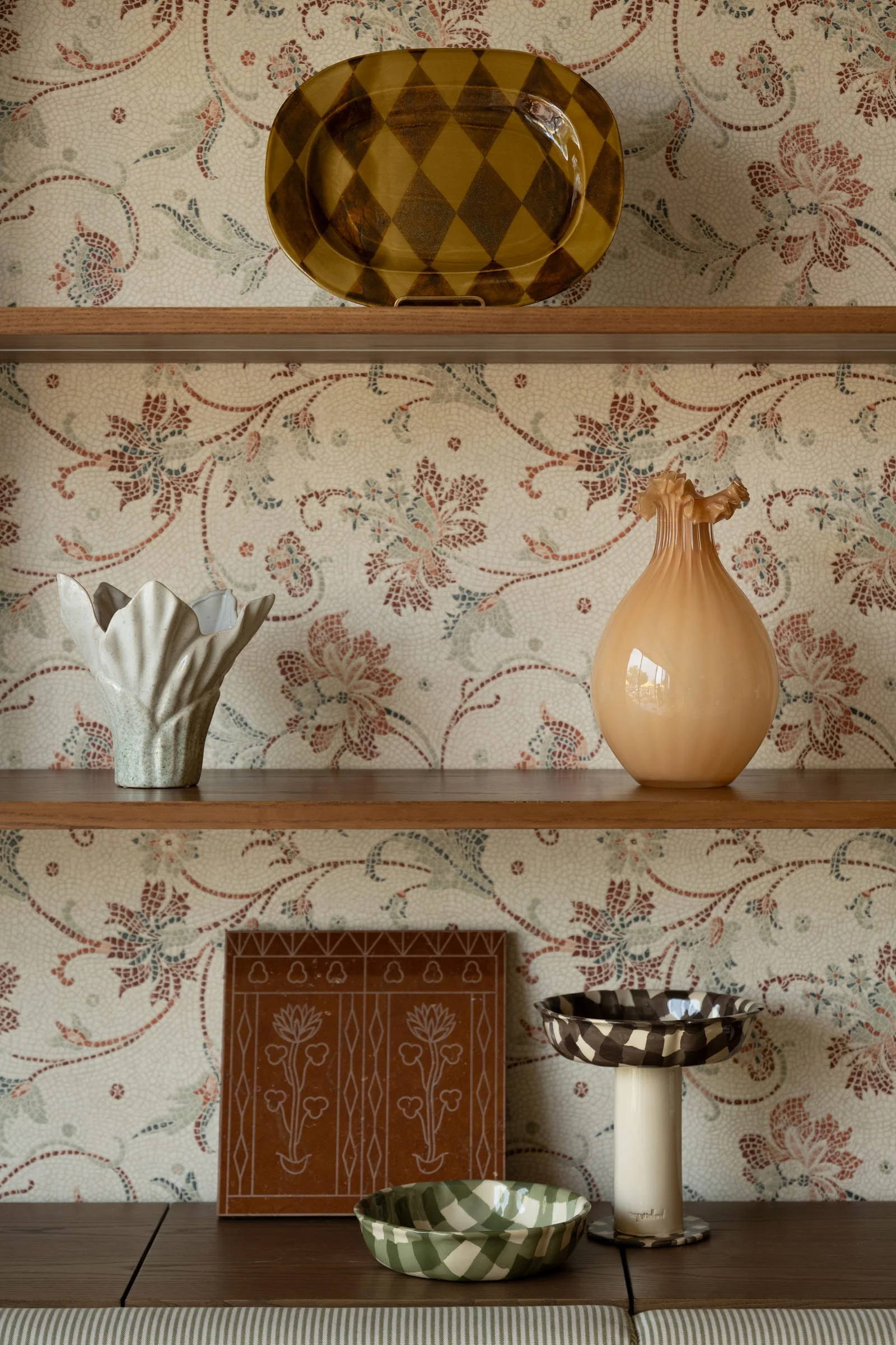 Floral wallpaper and custom mosaic details inside Chapter café
