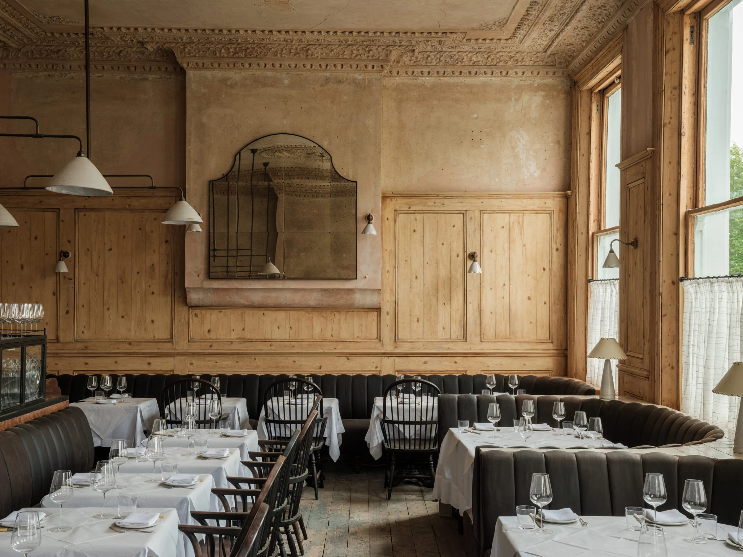 Candlelight catches the stripped wood and plaster walls at The Hero of Maida