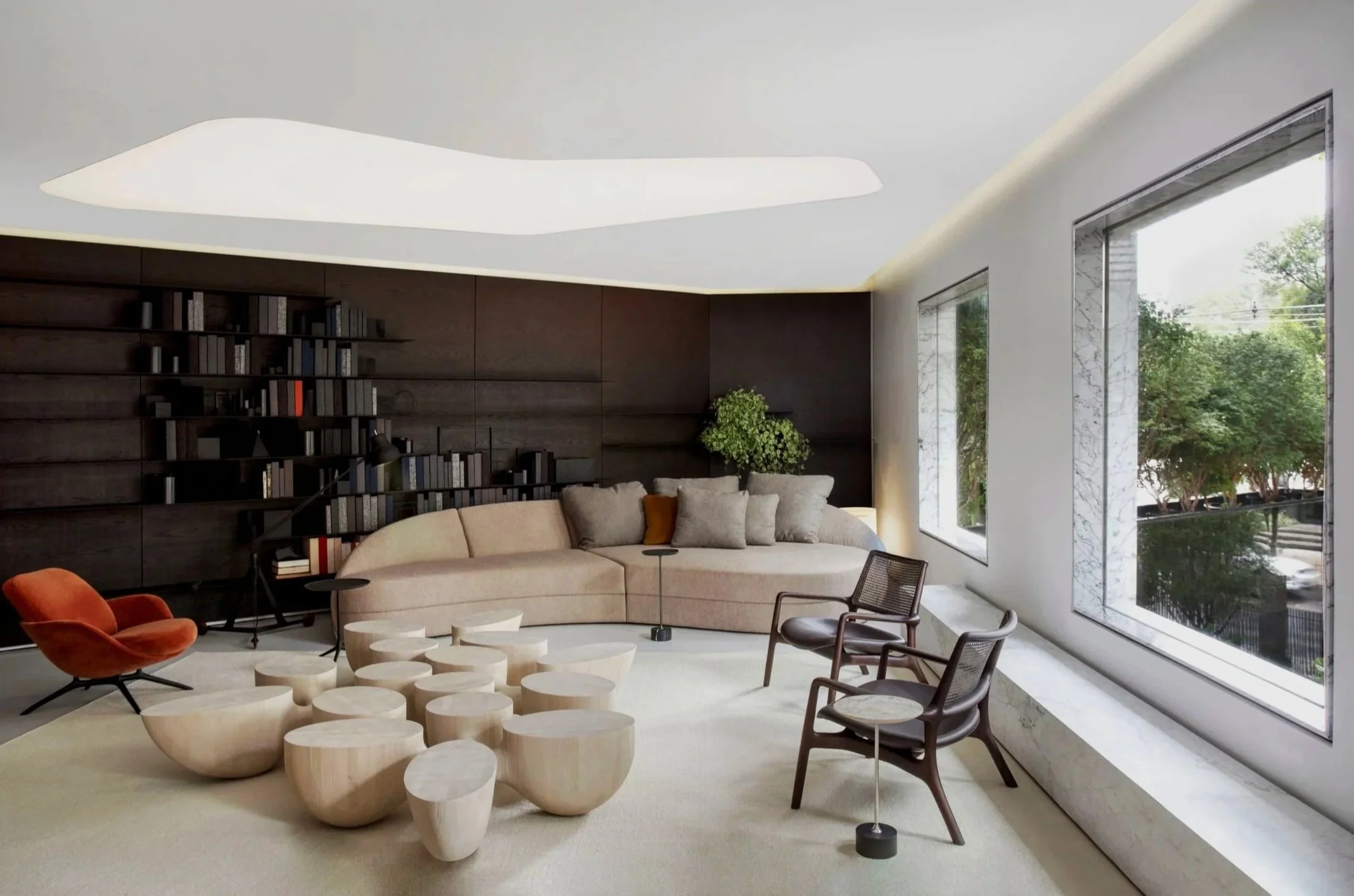Contemporary Brazilian furniture by Jader Almeida displayed in a refined showroom setting.