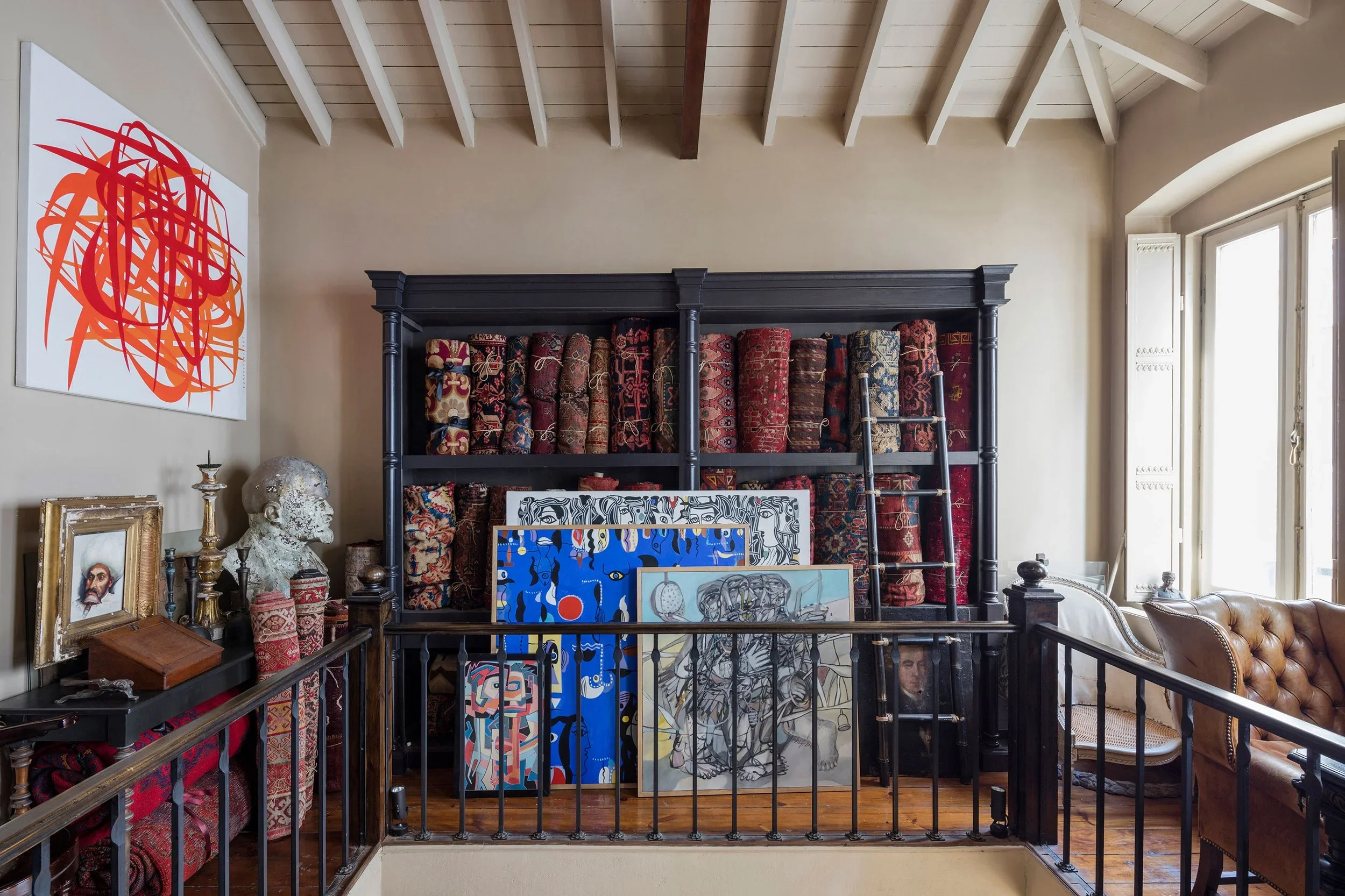 A curated space at Alaturca House, displaying antique carpets, art, and vintage decor in a historic building.