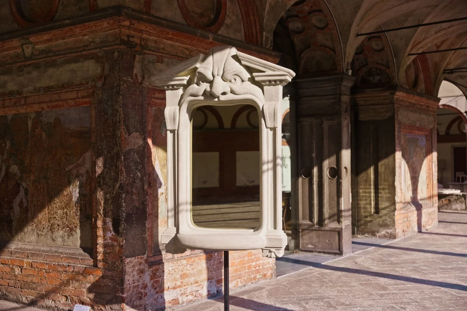 Chimera mirror by Francesco Maria Messina installed within the Renaissance cloisters of Santa Maria alla Fontana during Milan Design Week