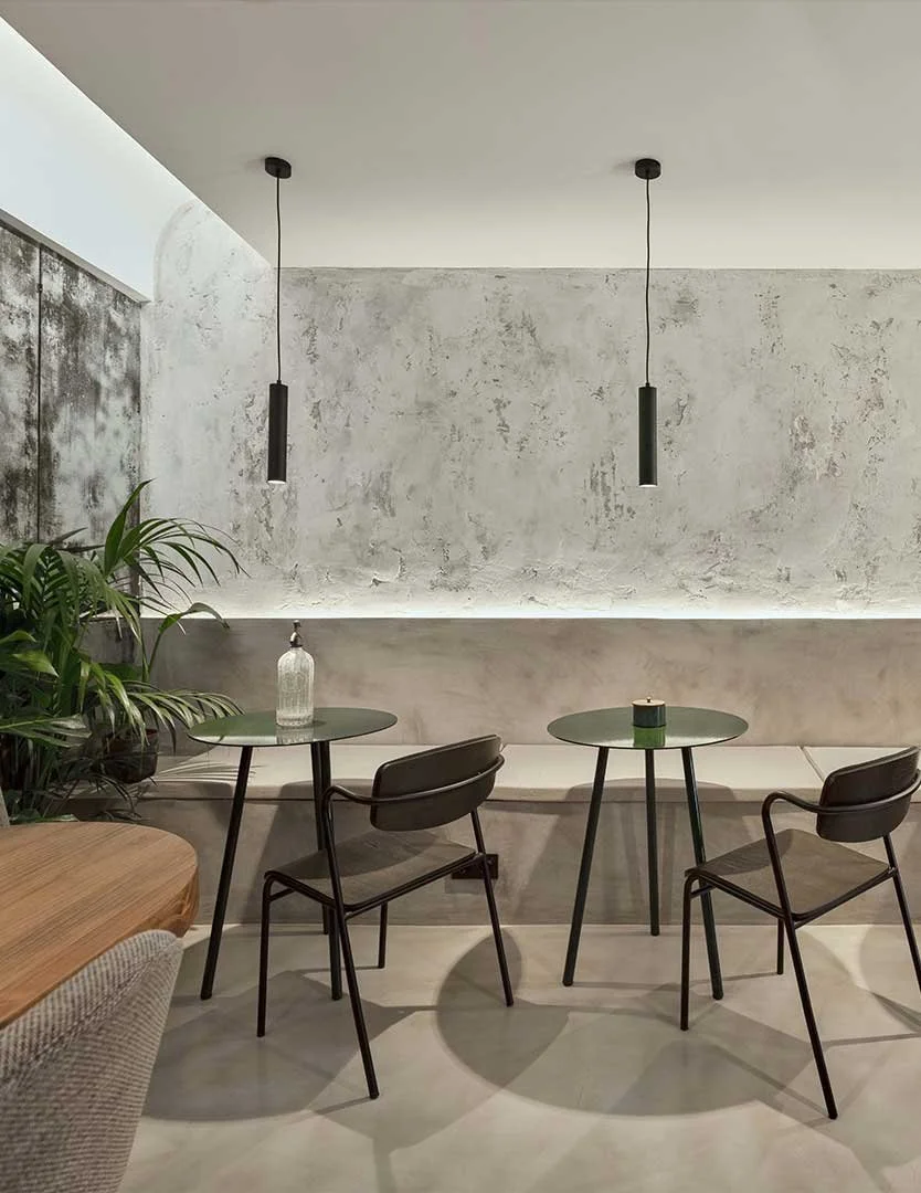 Intimate coffee space with warm lighting and tactile surfaces