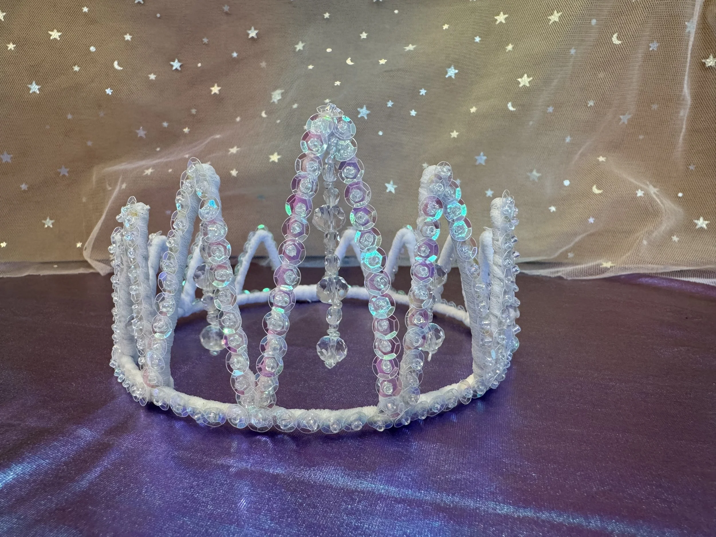 Crown with sequin- it has a pinkish color depending on the light.